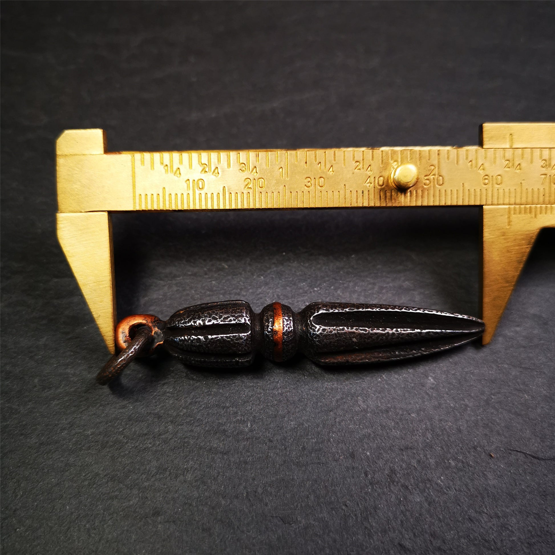 This handmade Dorje Phurba was crafted by Tibetan craftsmen from Hepo Town, Baiyu County, Tibet. The length is 2.5 inches,black color,the upper part is a vajra, and the lower part is a phurba. A copper wire is inlaid on the waist of the phurba.