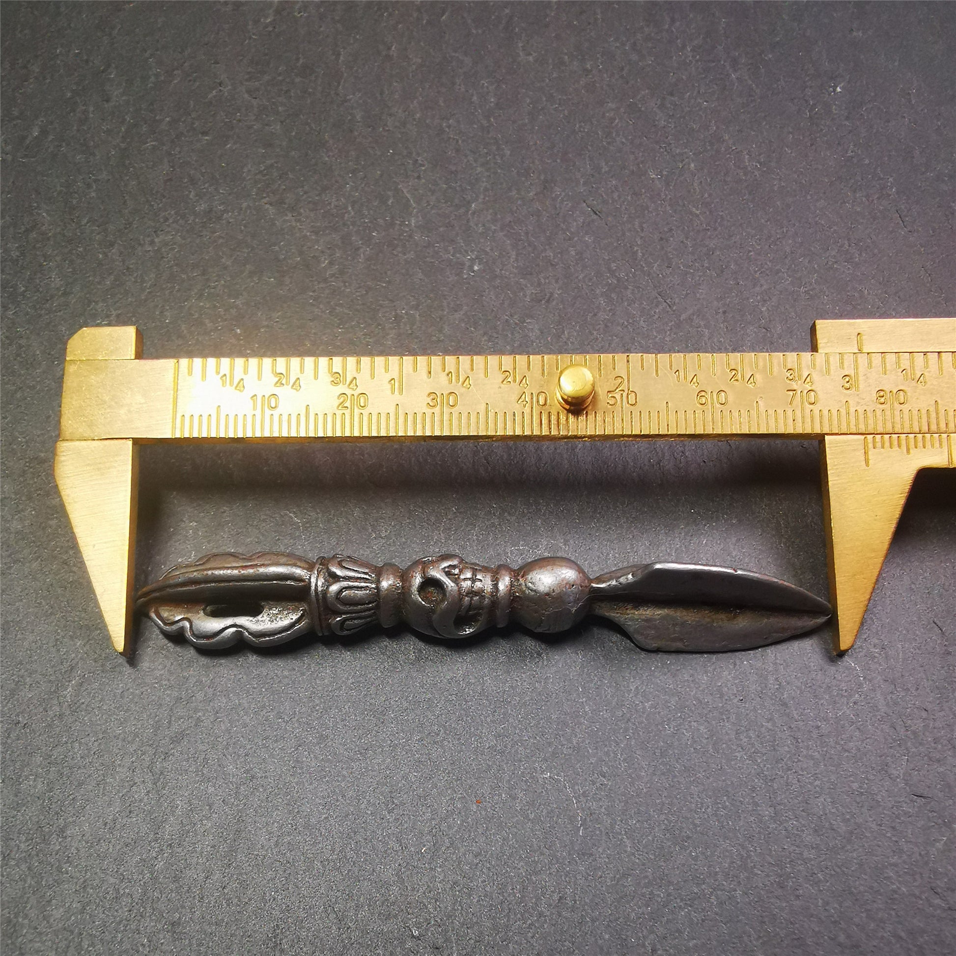 This phurba amulet was made of cold iron by Tibetan craftsmen in 1990's,its upper part is a vajra,and carved Shmashana Adhipati skull in the middle, the lower part is a Dorje Phurba,length is 3.0inches