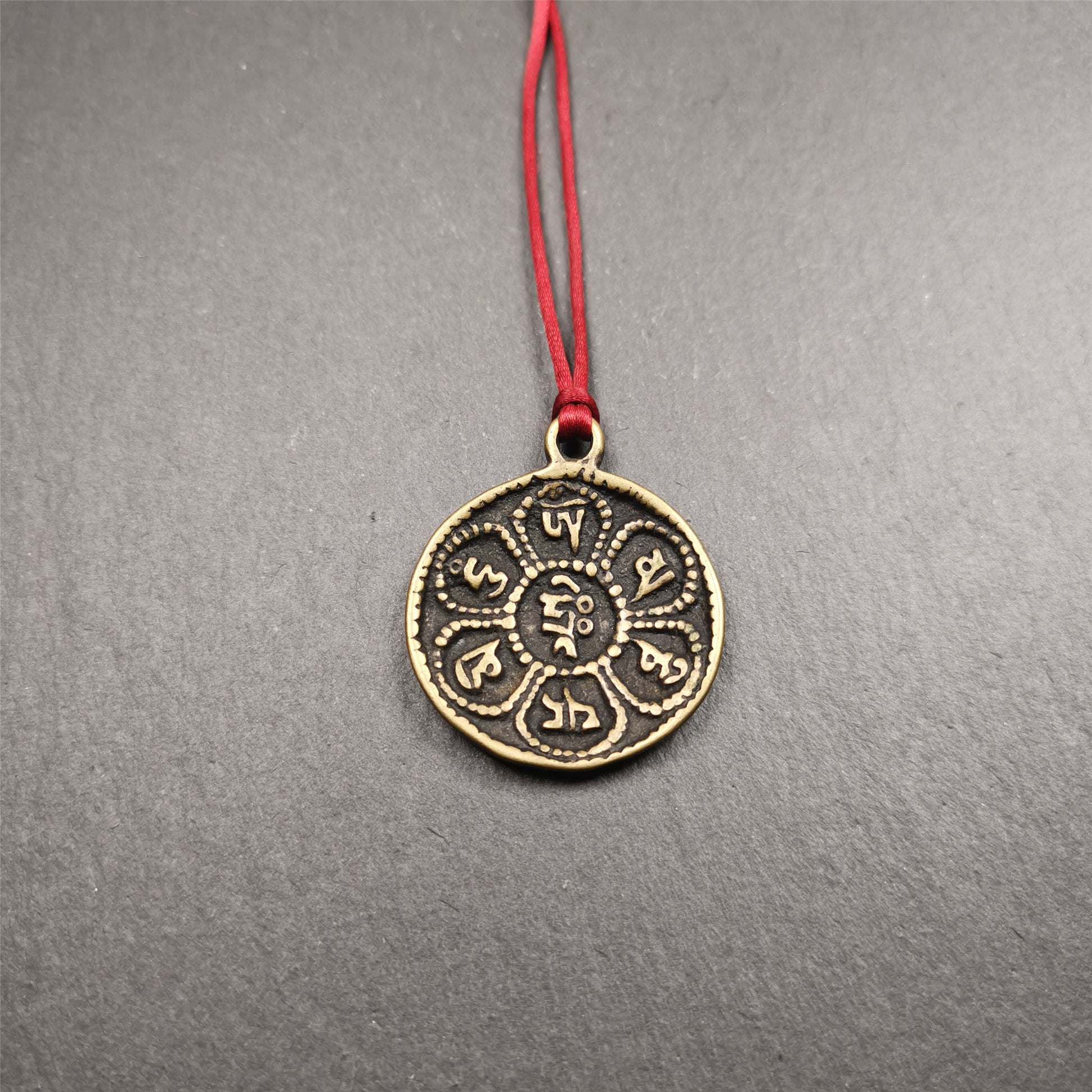 This om badge was made by Tibetan craftsmen and come from Hepo Town, Baiyu County, the birthplace of the famous Tibetan handicrafts. It is round, made of brass or white copper, 1.26 inches,carved with mantra of chenrezig OM MANI PADME HUM.
