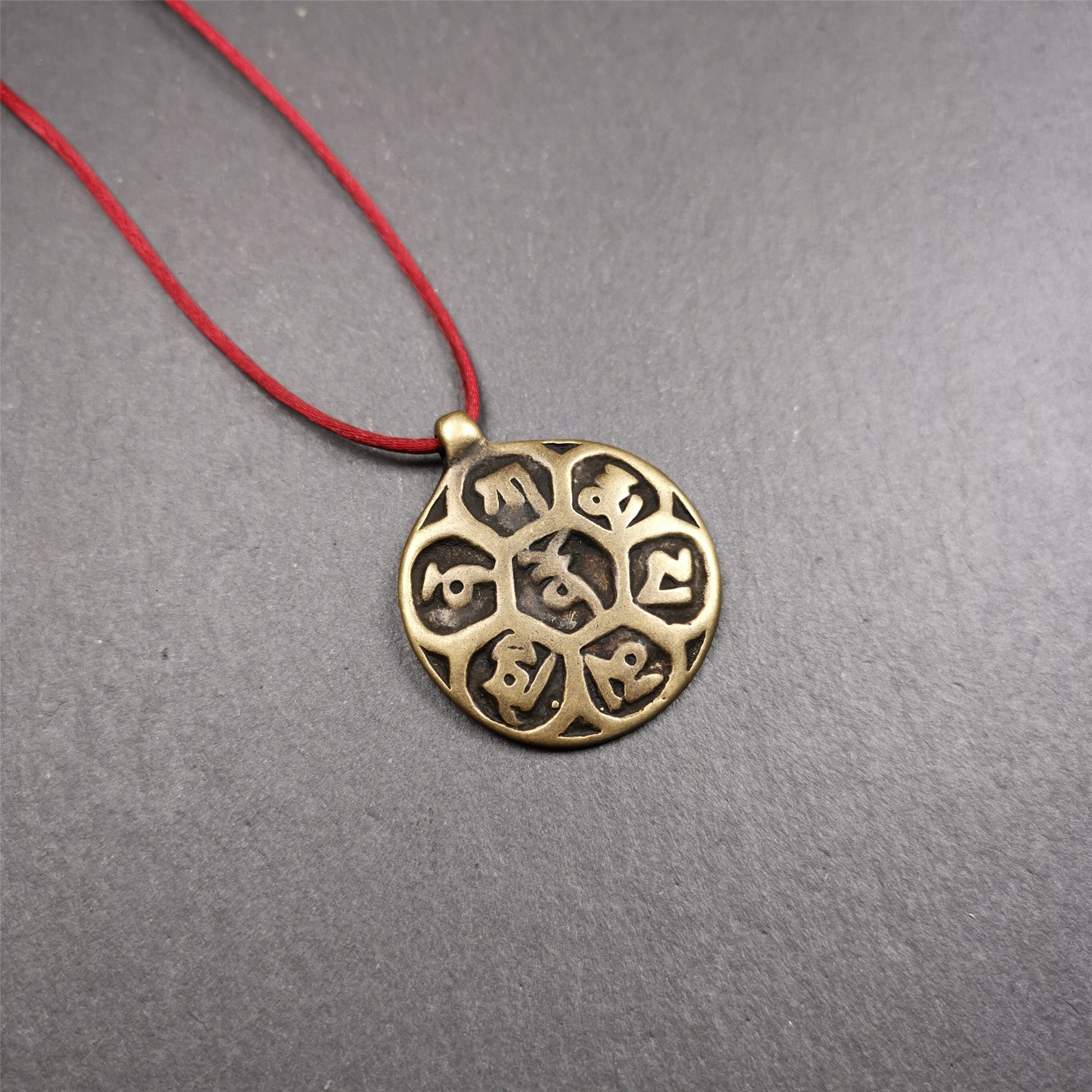 This om badge was made by Tibetan craftsmen and come from Hepo Town, Baiyu County, the birthplace of the famous Tibetan handicrafts. It is made of brass, 1.26 inches,carved with mantra of chenrezig OM MANI PADME HUM.