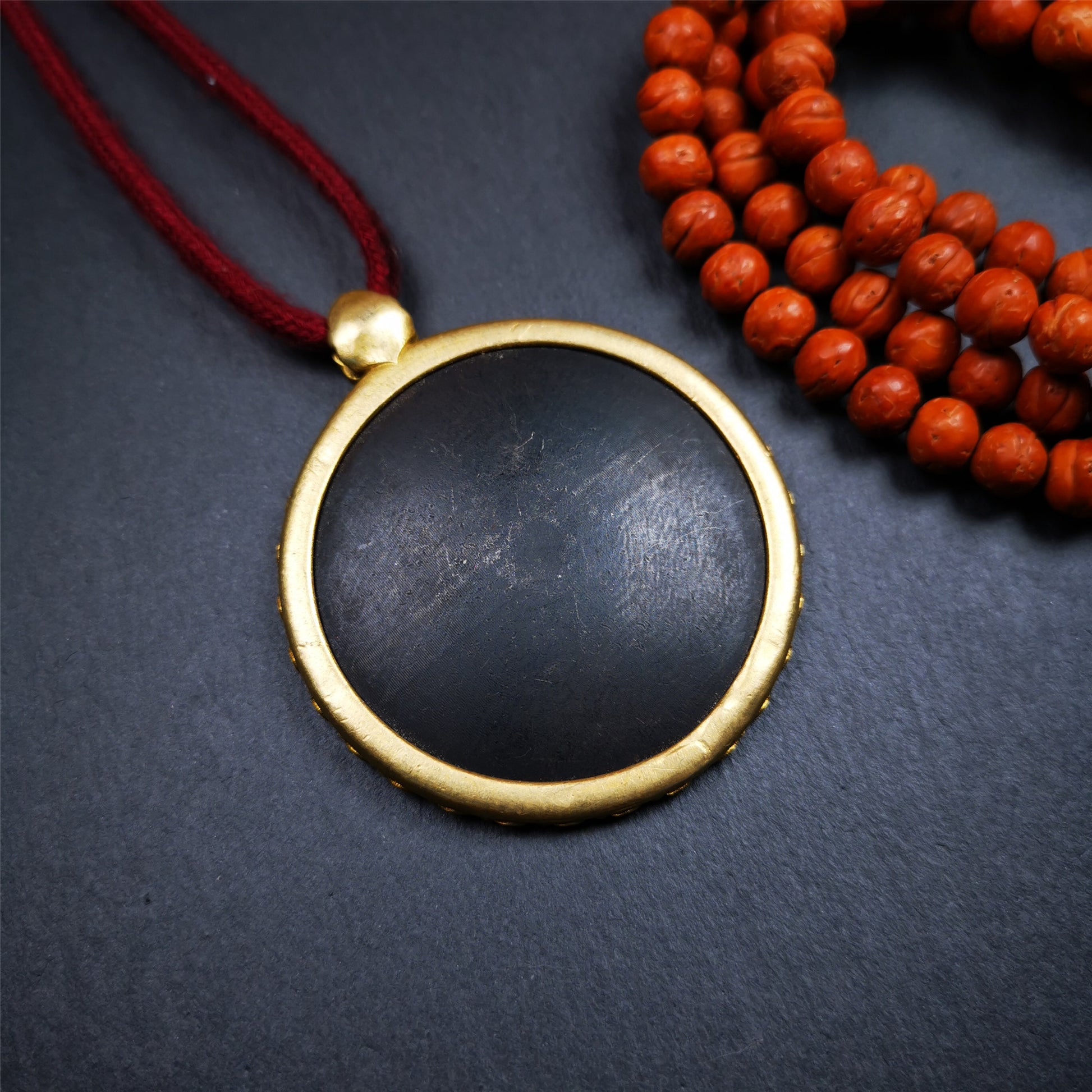 This badge is made by Tibetan craftsmen and come from Hepo Town, Baiyu County,Tibet. It is made of thokcha, edging with copper,round shape, 2.52 inche diameter. The OM MANI PADME HUM mantra arranged in concentric circles.