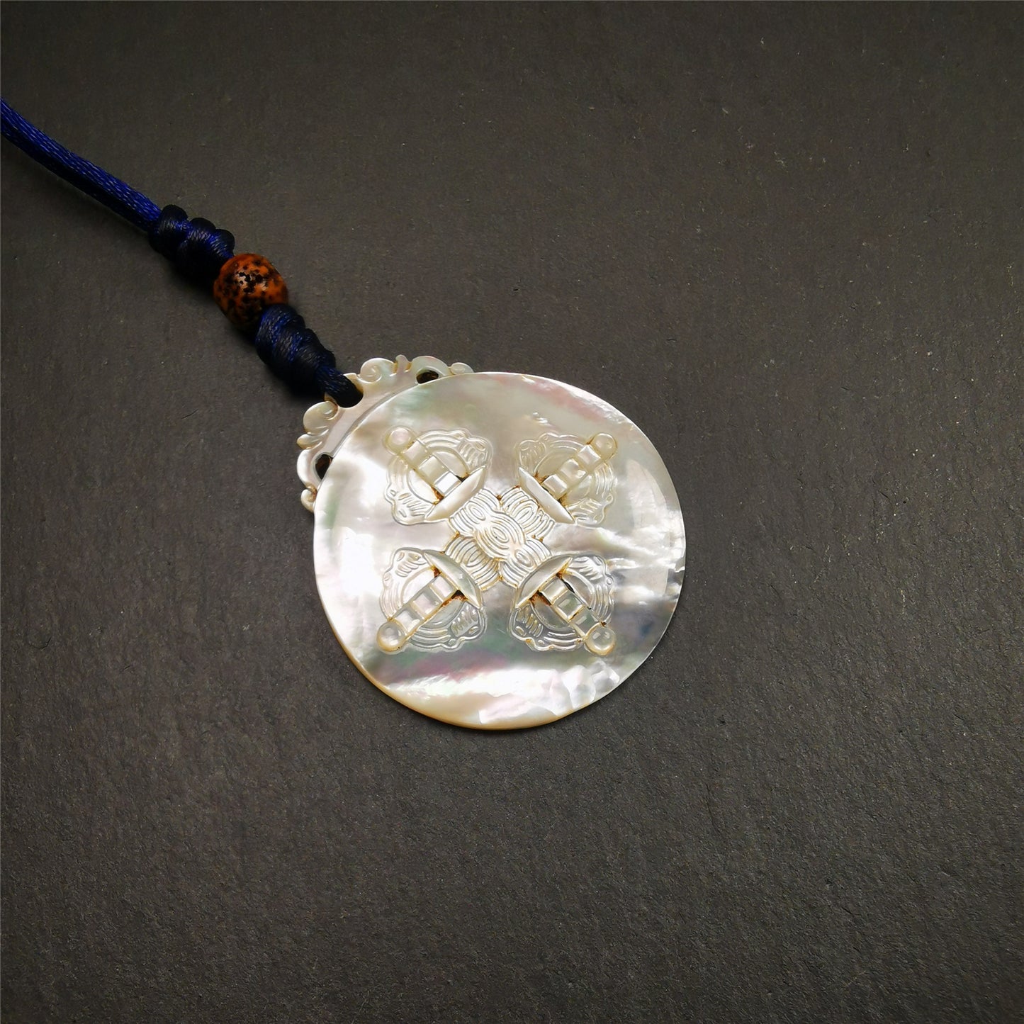 This unique Sipaho amulet was collected from  Derge Parkhang Tibet about 80 years old.  It was carved from shell,in different light and angles, it will emit unparalleled psychedelic colors.The front pattern is Tibetan Budhist calendar symbol - SIPAHO(srid pa ho),the back is cross vajra.