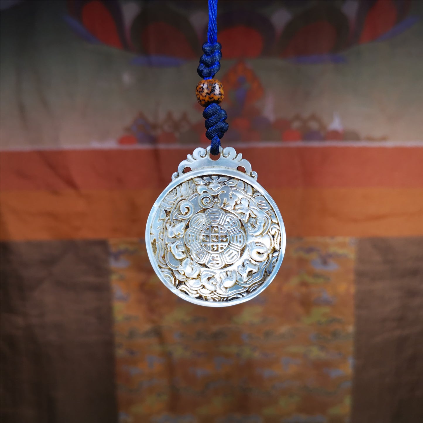 This unique Sipaho amulet was collected from  Derge Parkhang Tibet about 80 years old.  It was carved from shell,in different light and angles, it will emit unparalleled psychedelic colors.The front pattern is Tibetan Budhist calendar symbol - SIPAHO(srid pa ho),the back is cross vajra.