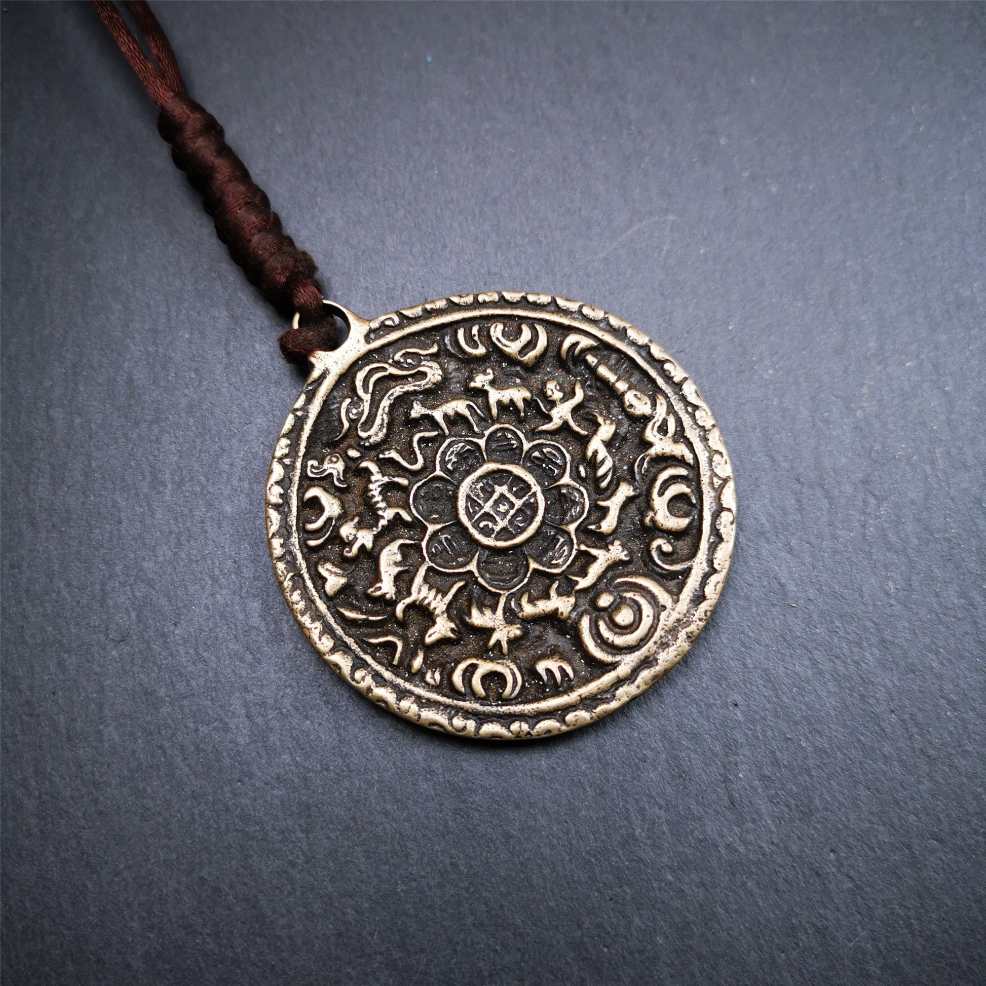 This unique Melong badge was collect from Kathok Monastery Tibet,about 60+ years old.It was sacred  amulets used by Kathok Monastery to present to believers,during a grand Dharma gathering,consecrated and blessed by lama.  It is made of thokcha,2.16 inch diameter,the front pattern is Tibetan Budhist calendar symbol - SIPAHO.