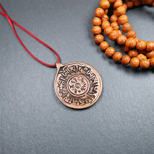 This Om badge amulet was collected from Yushu City Tibet,about 50 years old. It is round shape,made of lima brass, 1.46 inches,carved with mantra of chenrezig OM MANI PADME HUM. You can make it into a necklace, or a keychain, pendant
