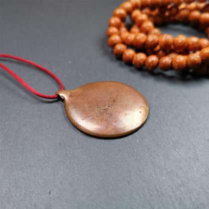 This Om badge amulet was collected from Yushu City Tibet,about 50 years old. It is round shape,made of lima brass, 1.46 inches,carved with mantra of chenrezig OM MANI PADME HUM. You can make it into a necklace, or a keychain, pendant
