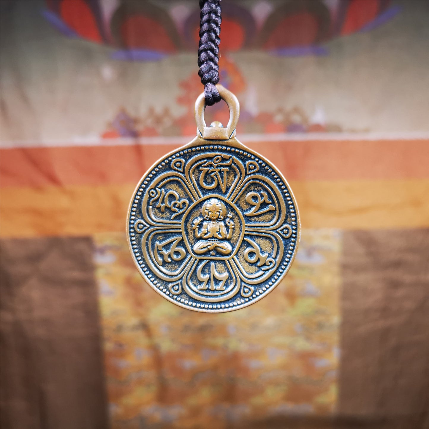 This OM badge amulet was collected from Jiegu Monastery Tibet.It is made of copper,diameter is 1.65 inches,Chenrezig is on the center, carved with Tibetan Letter ,Om Mani Padme Hum mantra,the letter on the back is Mind