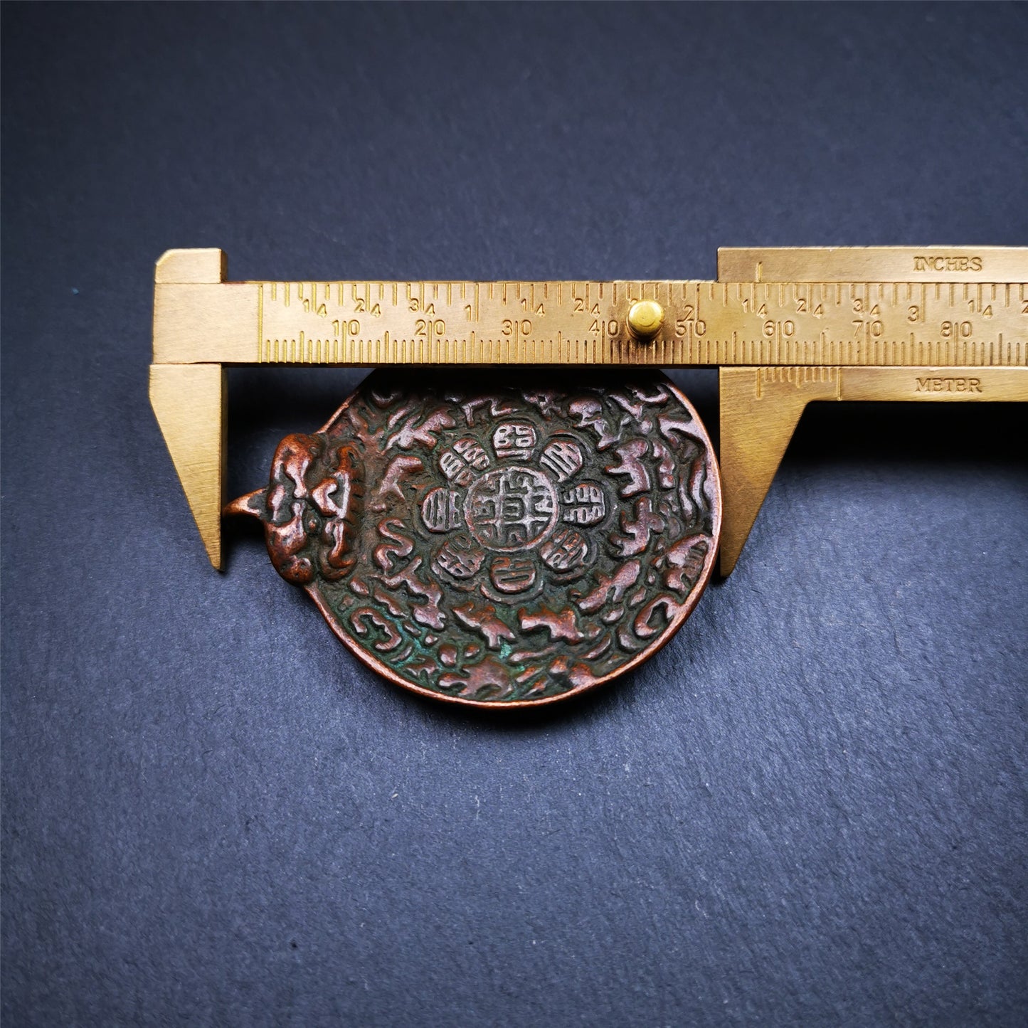 This unique melong badge was collected from Kathok Monastery for 50 years. It is round shape ,made of copper and carved 2 sided pattern. Its hanging ring is Kirtimukha,the fron is Tibetan Budhist calendar symbol - melong,and the back is mani jewel.