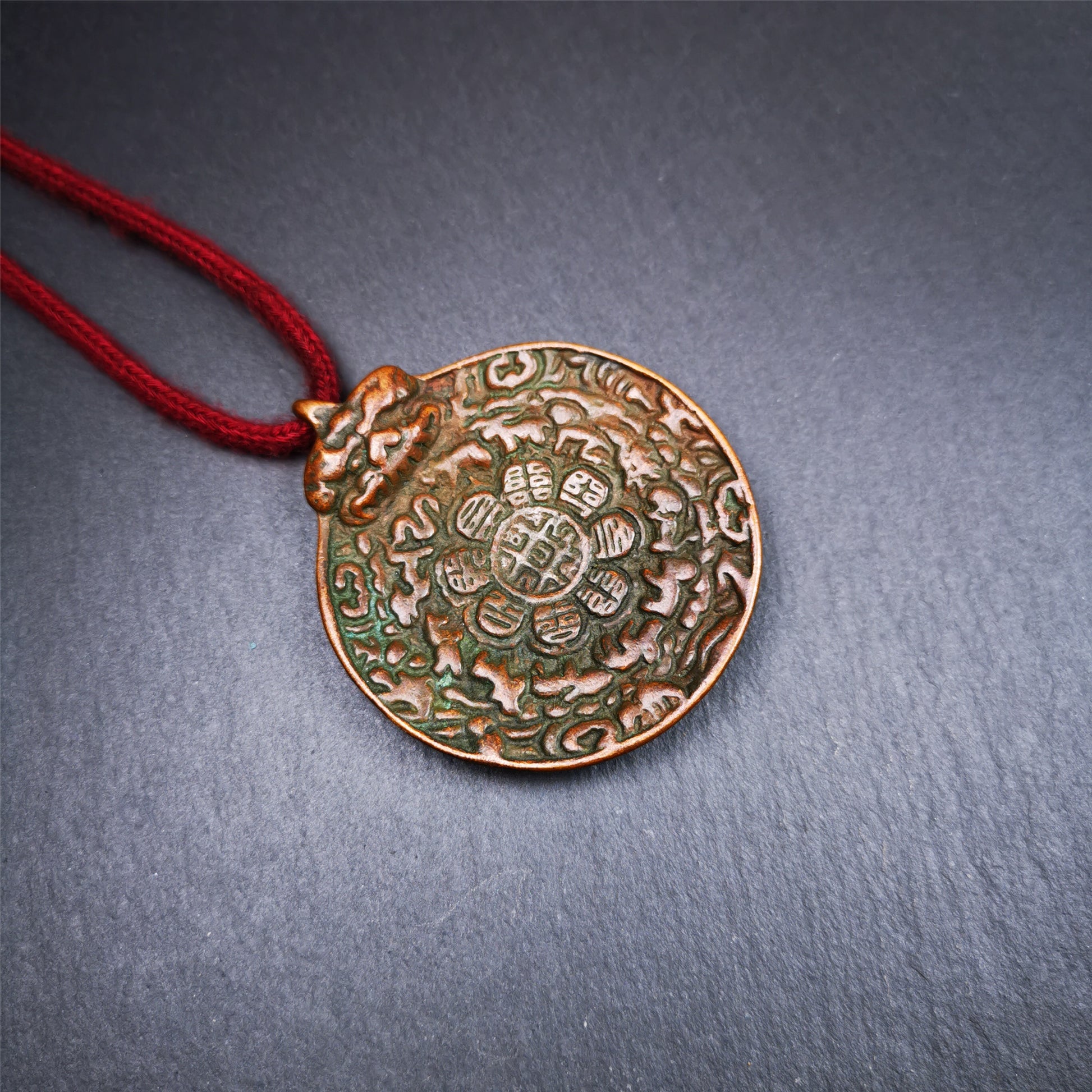 This unique melong badge was collected from Kathok Monastery for 50 years. It is round shape ,made of copper and carved 2 sided pattern. Its hanging ring is Kirtimukha,the fron is Tibetan Budhist calendar symbol - melong,and the back is mani jewel.