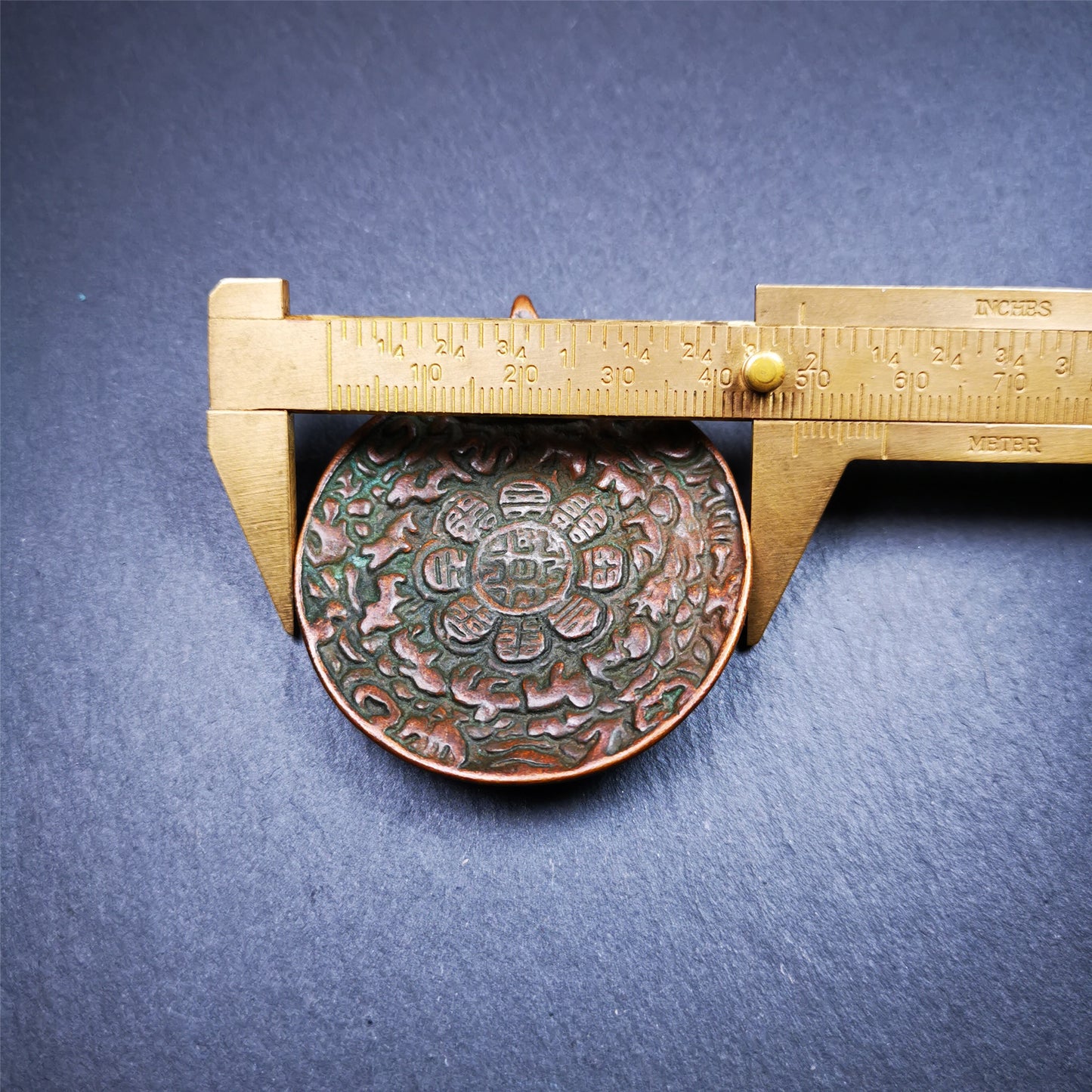 This unique melong badge was collected from Kathok Monastery for 50 years. It is round shape ,made of copper and carved 2 sided pattern. Its hanging ring is Kirtimukha,the fron is Tibetan Budhist calendar symbol - melong,and the back is mani jewel.