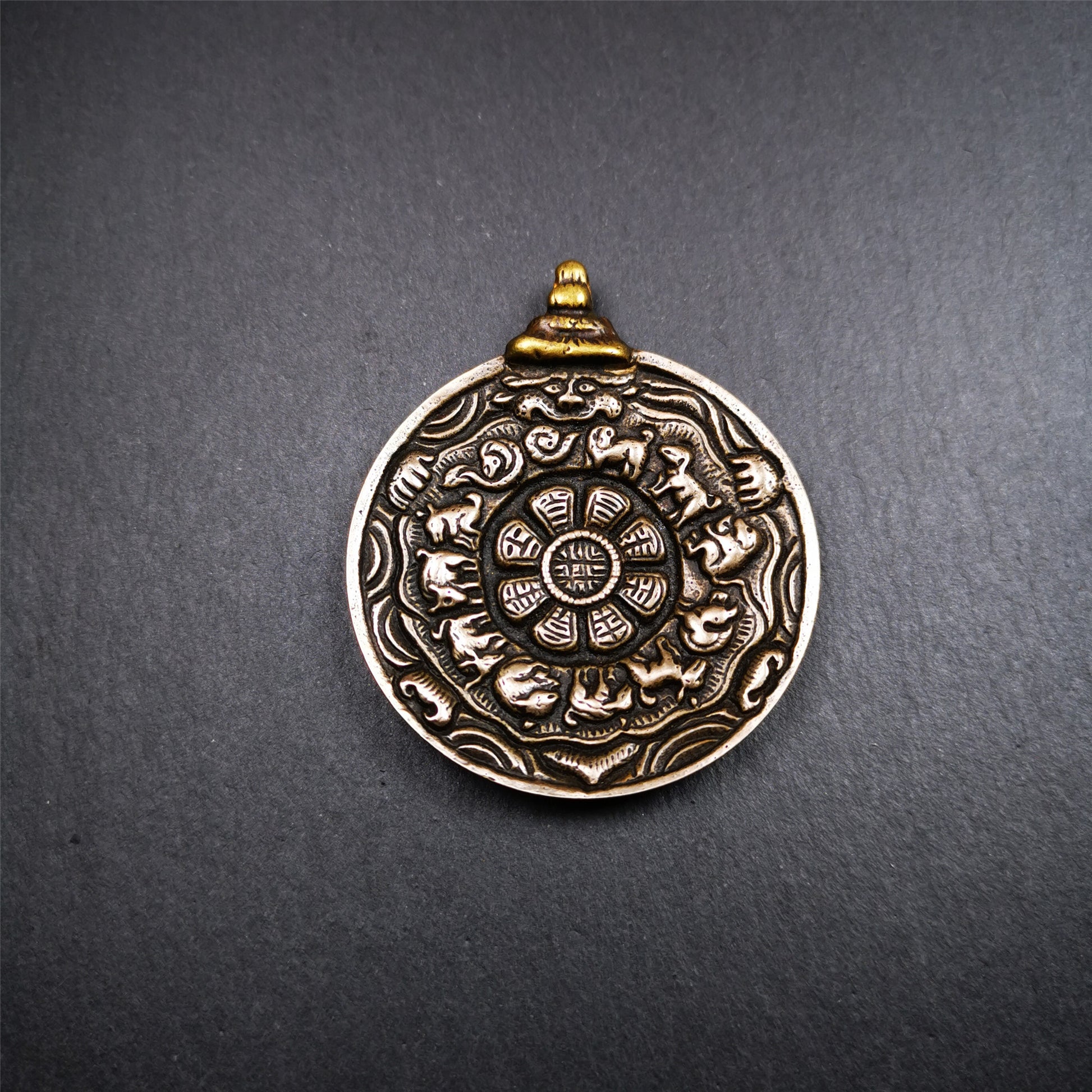 This melong calendar badge was collect from Kathok Monastery Tibet about 50+ years. This batch of melong are sacred  amulets used by Kathok Monastery to present to believers,consecrated and blessed by lama. It adopts a split casting method,1.89 inch.