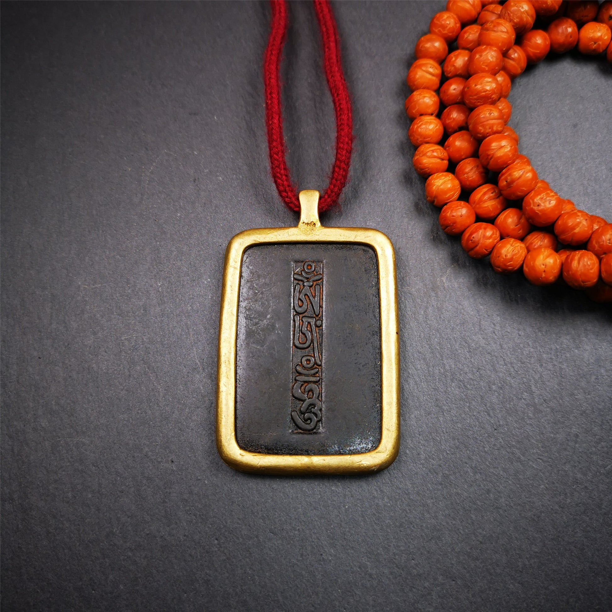 This badge is made by Tibetan craftsmen from Hepo Town, Baiyu County, the birthplace of the famous Tibetan handicrafts. It is made of copper, 2.52 × 1.57 inches. The front is the OM mantra and the back is body, speech, and mind.