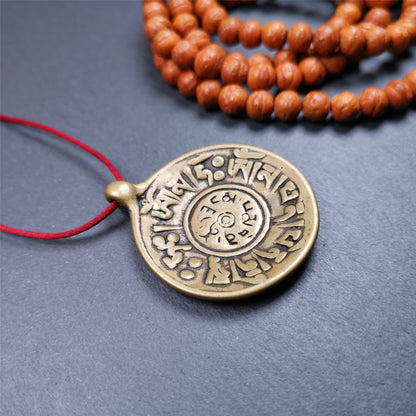 This Om badge amulet was collected from Yushu City Tibet,about 50 years old. It is round shape,made of lima brass, 1.65 inches,carved with mantra of chenrezig OM MANI PADME HUM. You can make it into a necklace, or a keychain, pendant