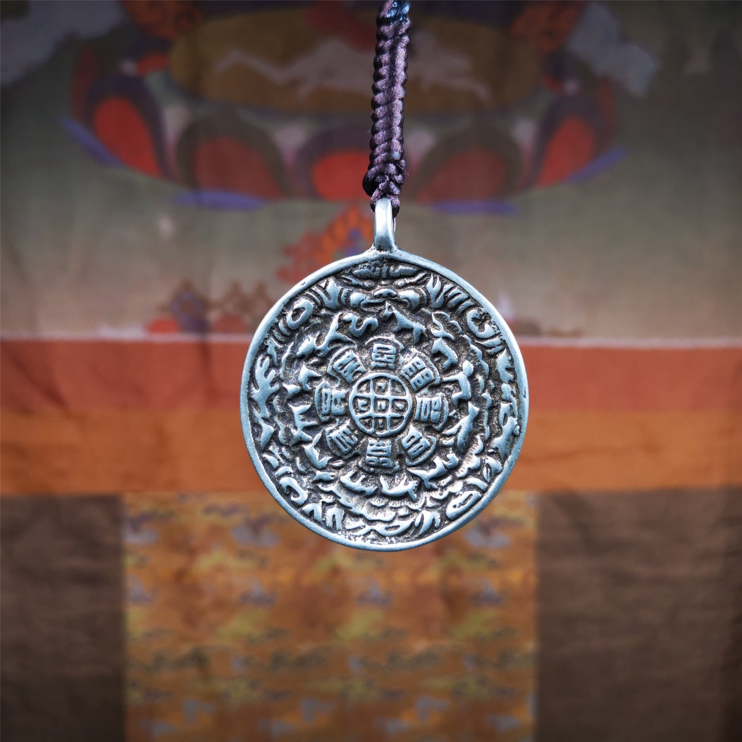 This type of Kirtimukha melong amulet was made by Tibetan craftsmen and come from Hepo Town, Baiyu County, Tibet.  It is made of copper,1.7 inch diameter,the front is Tibetan Budhist amulet symbol - Melong / sipaho,tha back is Kirtimukha.