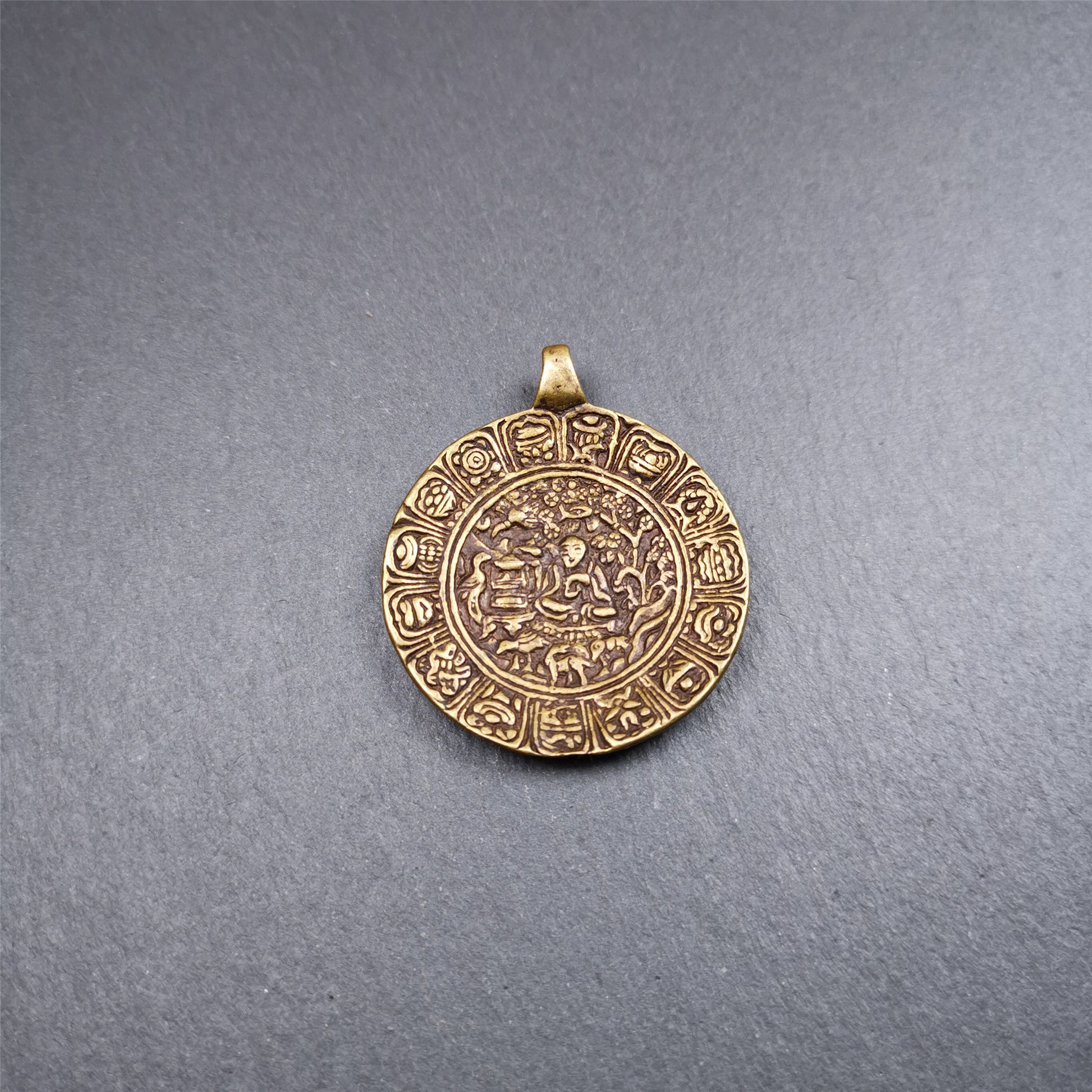 This Longevity Badge was handmade by Tibetan craftsmen and come from Hepo Town, Baiyu County, Tibet. It is made of brass,round shape,the theme is the god of longevity,surrounded by the symbols of Ashtamangala.