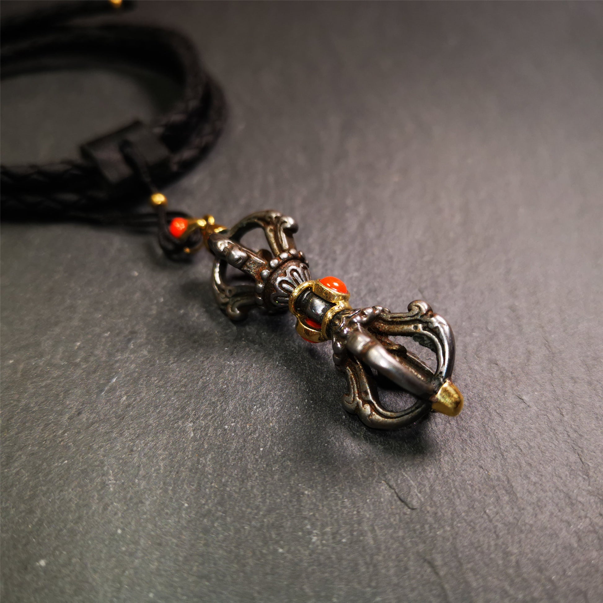 This unique vajra pendant was handmade by Tibetan craftsmen from Tibet in 1990's,from Hepo Town, Baiyu County, the birthplace of the famous Tibetan handicrafts. It is five-pronged Vajra,made of cold iron, 1.77 inch height.Comes with leather cord. You can make it a necklace, pendant, keychain, mala pendant, or just as an ornament on your desk.