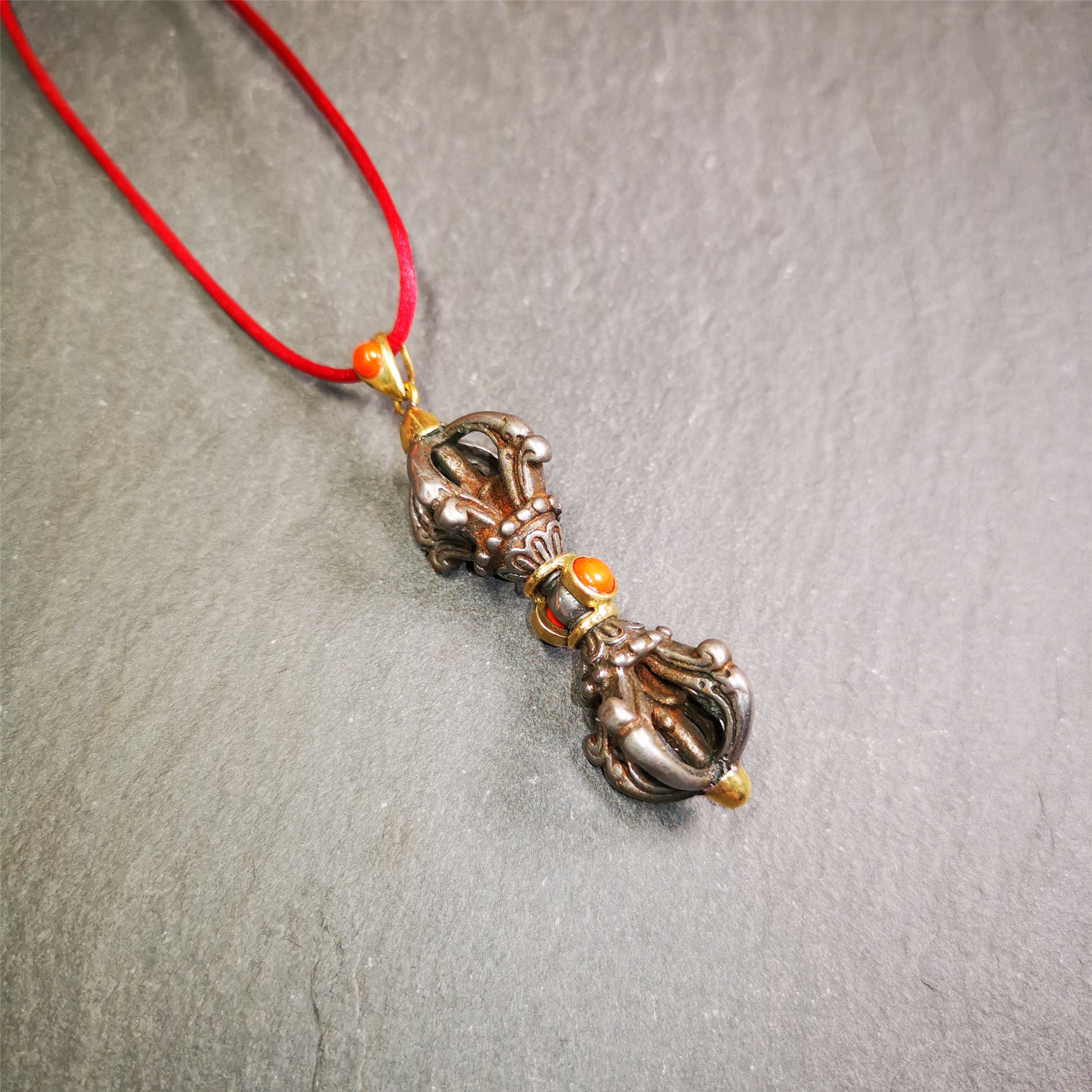 This unique vajra pendant was handmade by Tibetan craftsmen from Tibet in 1990's,from Hepo Town, Baiyu County, the birthplace of the famous Tibetan handicrafts. It is five-pronged Vajra,made of cold iron, 1.77 inch height.Comes with leather cord. You can make it a necklace, pendant, keychain, mala pendant, or just as an ornament on your desk.