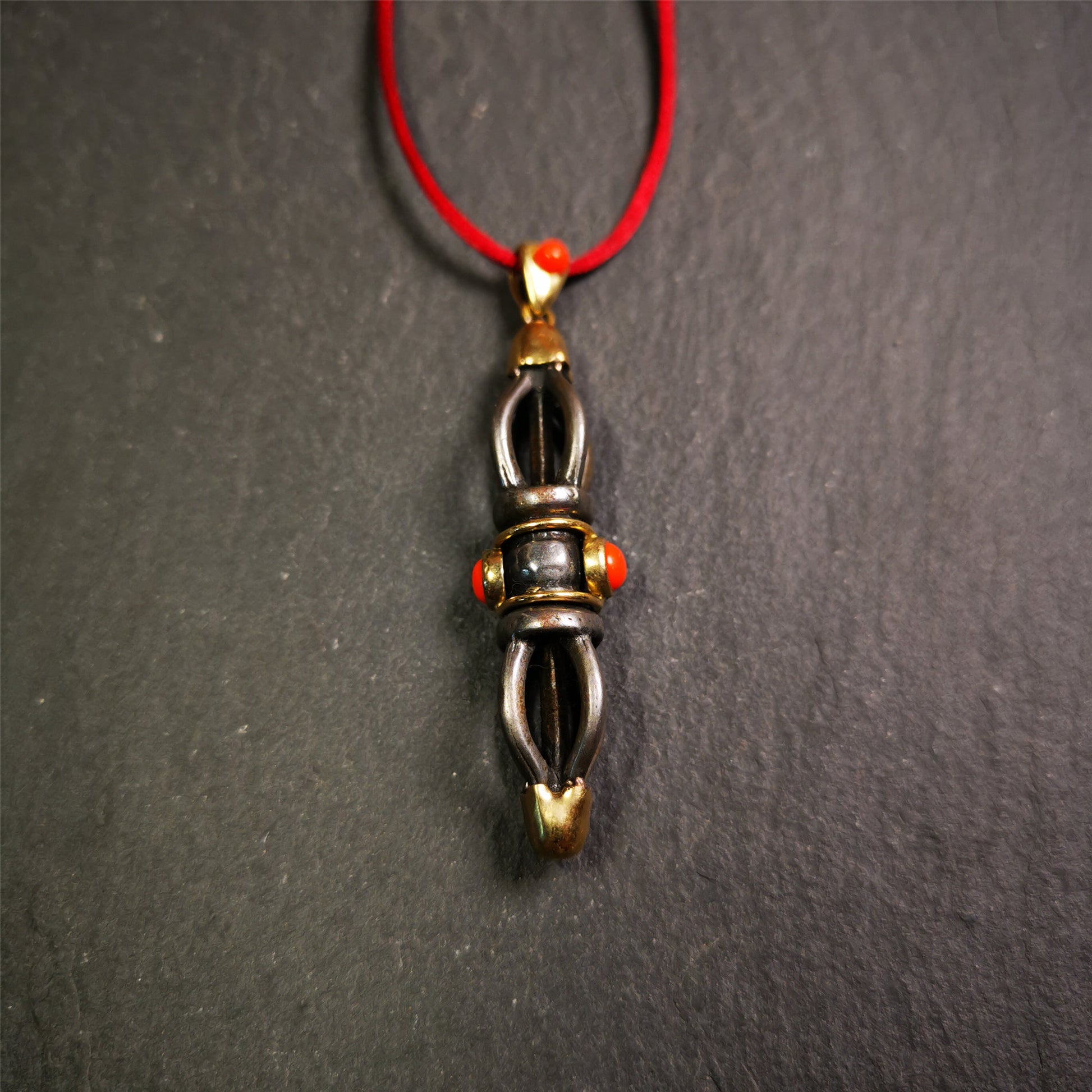 This unique vajra pendant was handmade by Tibetan craftsmen from Tibet in 1990s,from Hepo Town, Baiyu County, the birthplace of the famous Tibetan handicrafts. It is five-pronged Vajra,made of cold iron, 1.77 inch height.Comes with leather cord.