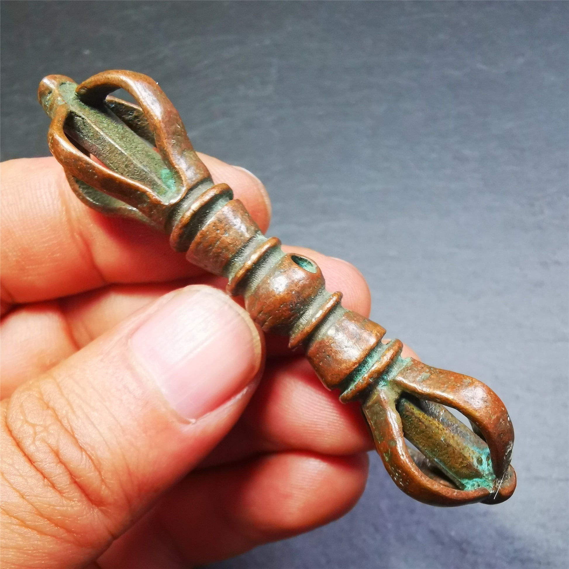 This unique vajra pendant was handmade by Tibetan craftsmen from Tibet in 1990s,from Hepo Town, Baiyu County, the birthplace of the famous Tibetan handicrafts. It is five-pronged Vajra,made of copper, brown color,2.76 inches length.
