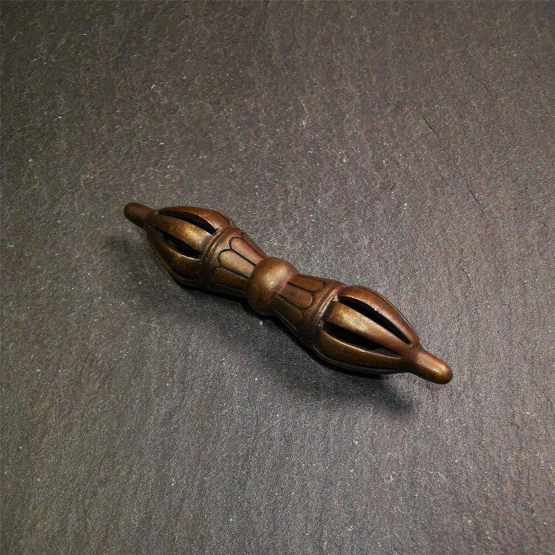 This unique vajra pendant was handmade by Tibetan craftsmen from Tibet in 1990s,from Hepo Town, Baiyu County, the birthplace of the famous Tibetan handicrafts. It is nine-pronged Vajra,made of copper, brown color,2.76 inches length.