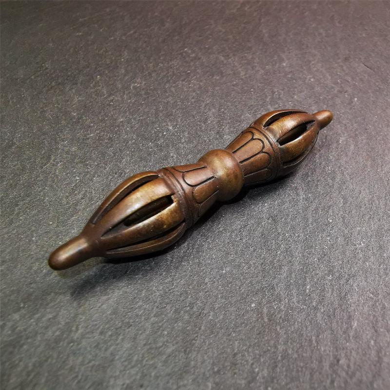 This unique vajra pendant was handmade by Tibetan craftsmen from Tibet in 1990s,from Hepo Town, Baiyu County, the birthplace of the famous Tibetan handicrafts. It is nine-pronged Vajra,made of copper, brown color,2.76 inches length.