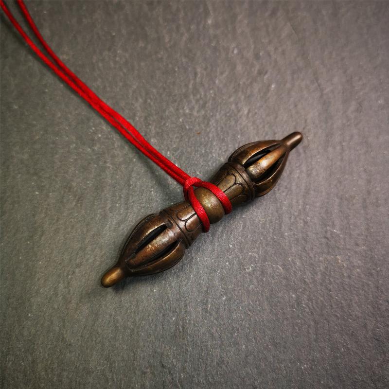 This unique vajra pendant was handmade by Tibetan craftsmen from Tibet in 1990s,from Hepo Town, Baiyu County, the birthplace of the famous Tibetan handicrafts. It is nine-pronged Vajra,made of copper, brown color,2.76 inches length.