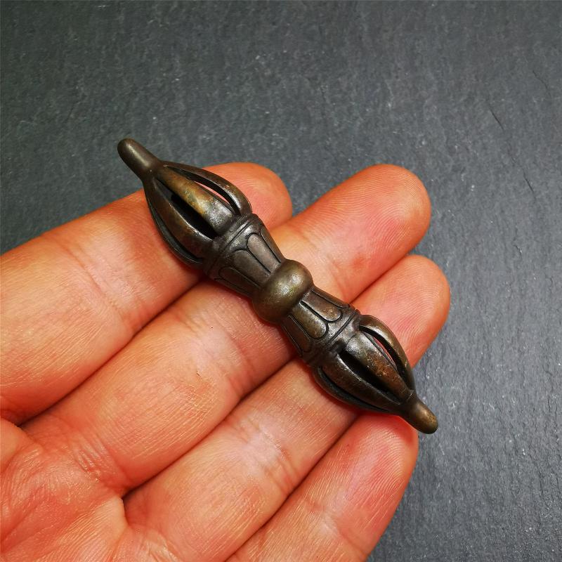 This unique vajra pendant was handmade by Tibetan craftsmen from Tibet in 1990s,from Hepo Town, Baiyu County, the birthplace of the famous Tibetan handicrafts. It is nine-pronged Vajra,made of copper, brown color,2.76 inches length.