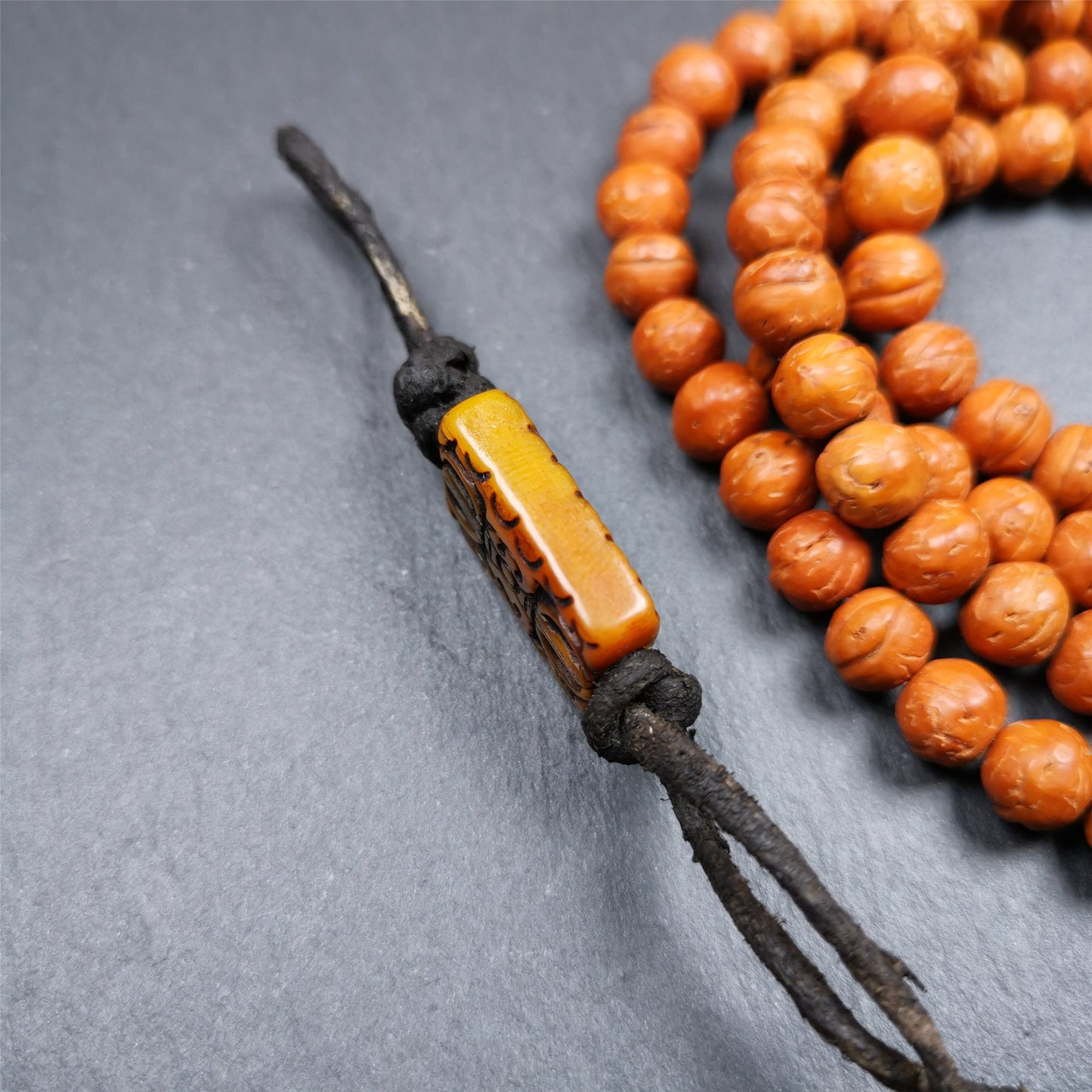 This unique vajra amulet was handmade by Tibetan craftsmen from Tibet in 1990's,blessed in Gengqing Monastry. It is entirely hand-carved yak bone craft, double sided with vajra and other patterns,very beautiful. You can use it as pendant, keychain, bag hanging,or altar rituals .