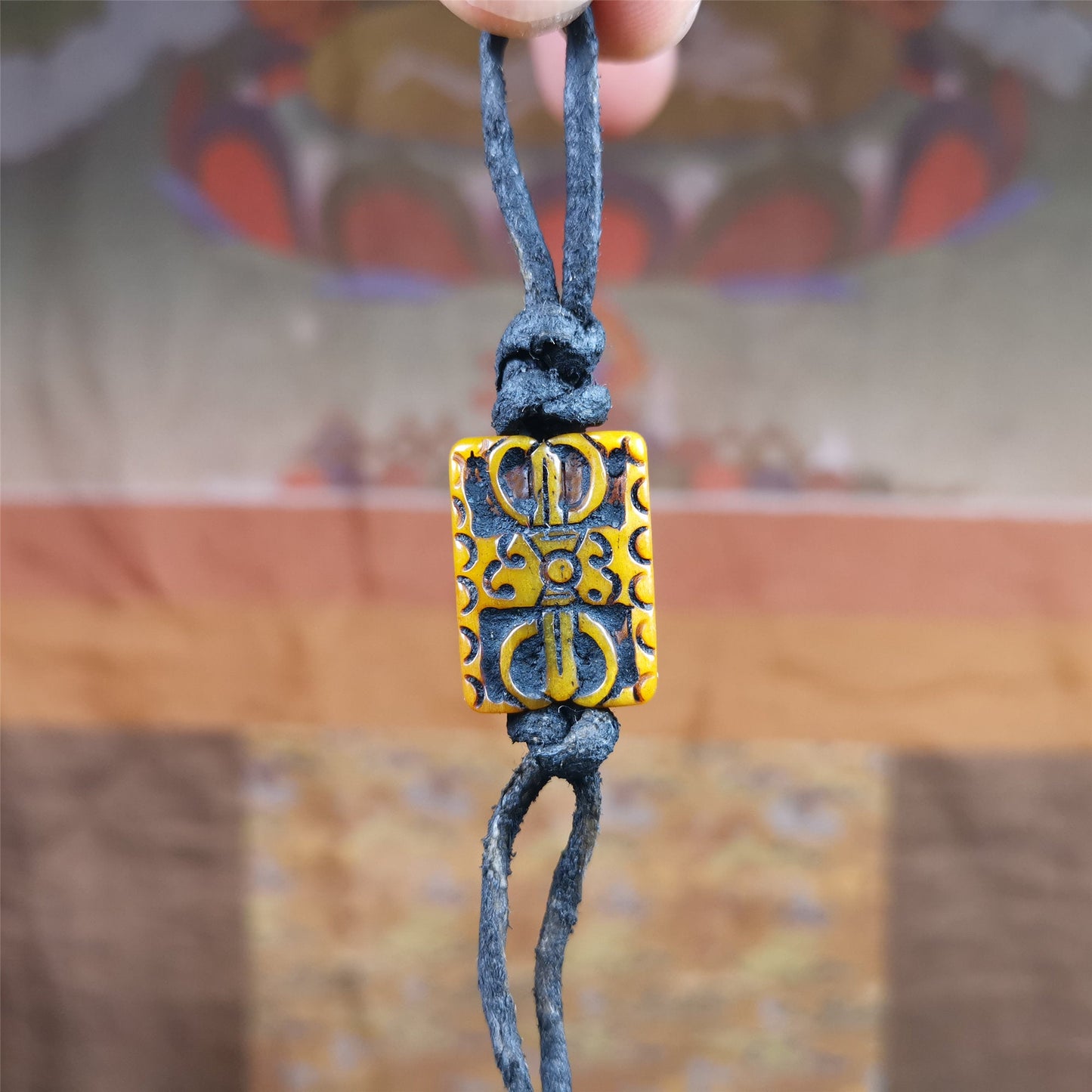 This unique vajra amulet was handmade by Tibetan craftsmen from Tibet in 1990's,blessed in Gengqing Monastry. It is entirely hand-carved yak bone craft, double sided with vajra and other patterns,very beautiful. You can use it as pendant, keychain, bag hanging,or altar rituals .