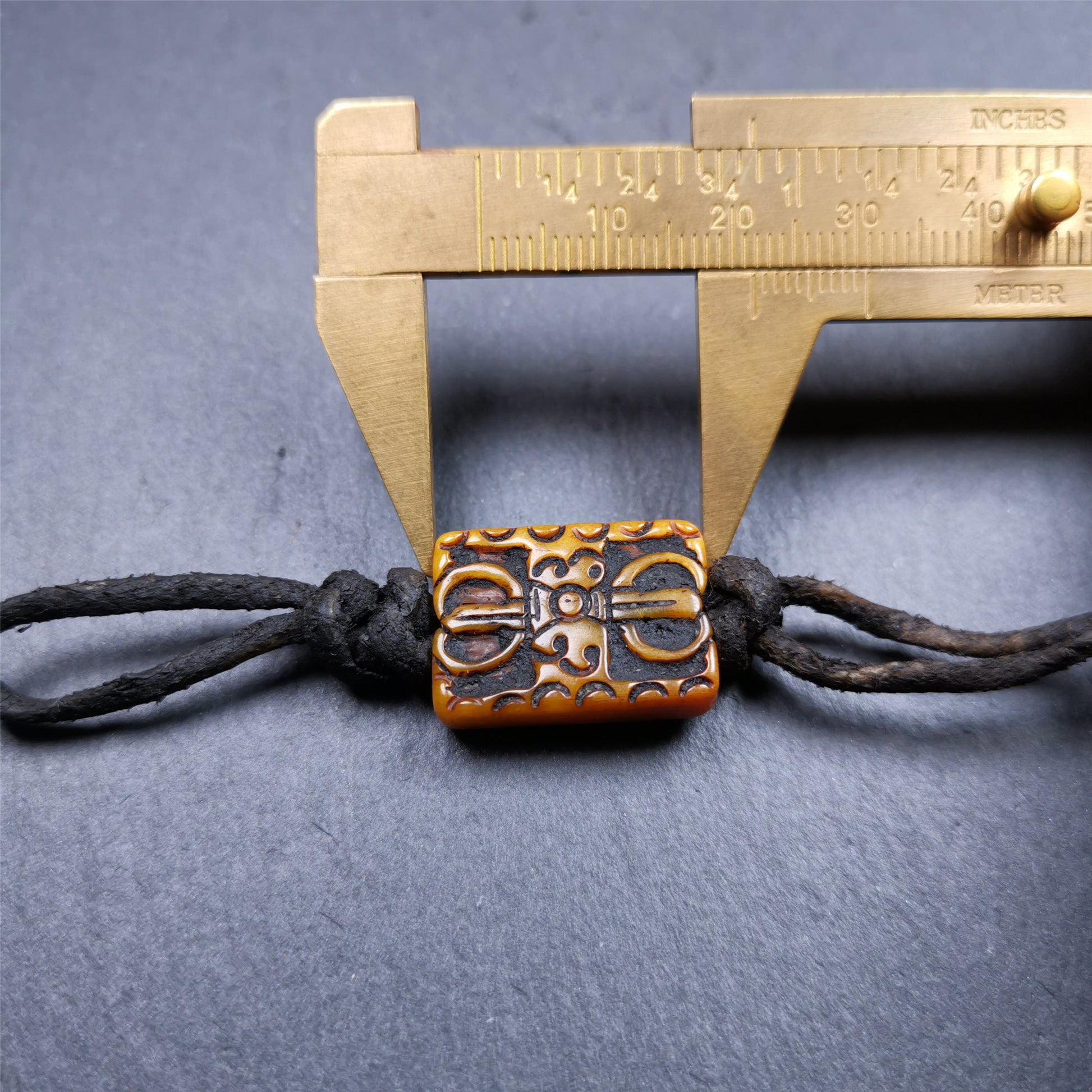 This unique vajra amulet was handmade by Tibetan craftsmen from Tibet in 1990's,blessed in Gengqing Monastry. It is entirely hand-carved yak bone craft, double sided with vajra and other patterns,very beautiful. You can use it as pendant, keychain, bag hanging,or altar rituals .