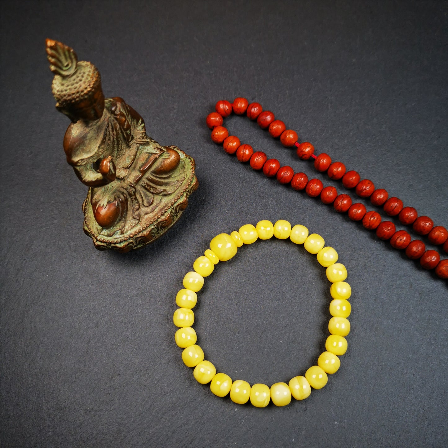 This amber beads bracelet was hand-woven by Tibetans from Baiyu County,Tibet. It is made of amber, yellow color,consists 1 main bead,25 small beads and 2 spacer beads,tie with elastic cord to fit your wrist.