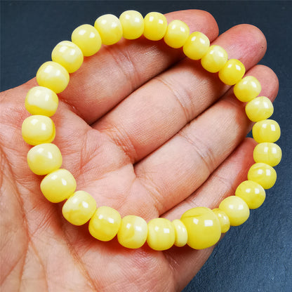 This amber beads bracelet was hand-woven by Tibetans from Baiyu County,Tibet. It is made of amber, yellow color,consists 1 main bead,25 small beads and 2 spacer beads,tie with elastic cord to fit your wrist.