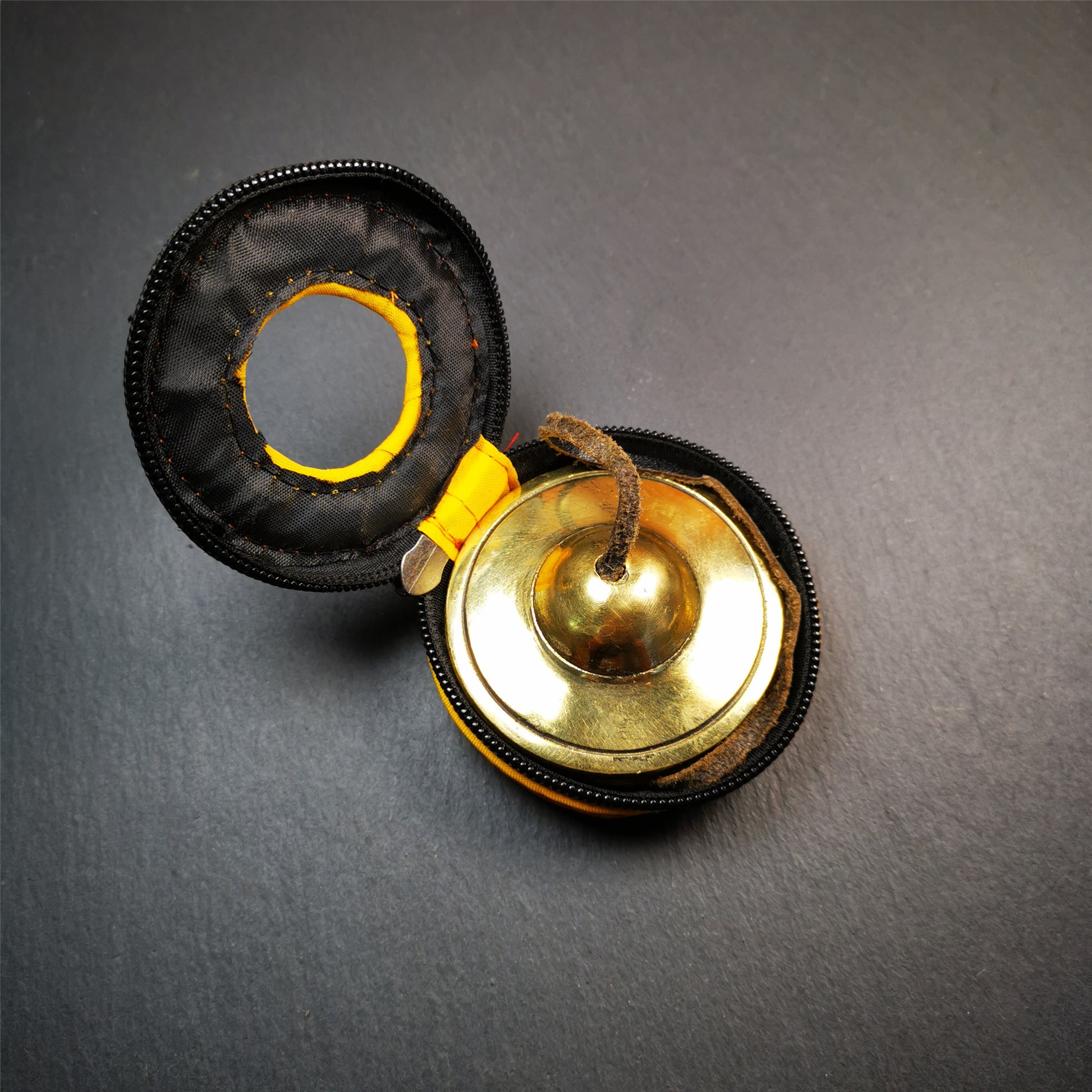 This tingsha bell set was handmade in Nepal,using traditional techniques and materials. It was made of brass,6.5cm diameter,shiny color,with pure, clear and resonant,good for meditation. Come with tingsha case.