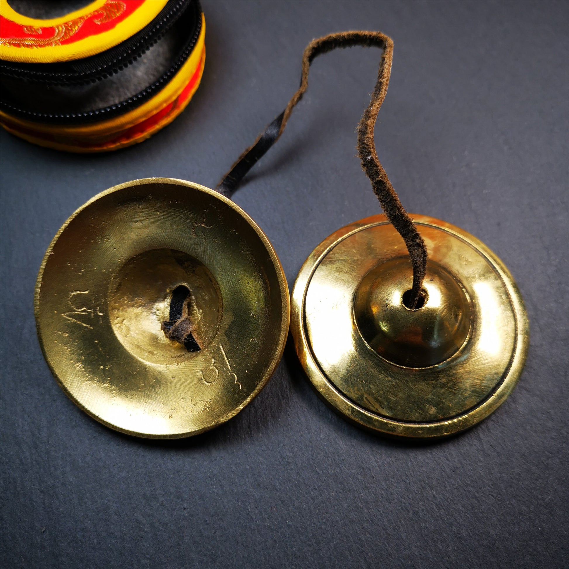 This tingsha bell set was handmade in Nepal,using traditional techniques and materials. It was made of brass,6.5cm diameter,shiny color,with pure, clear and resonant,good for meditation. Come with tingsha case.