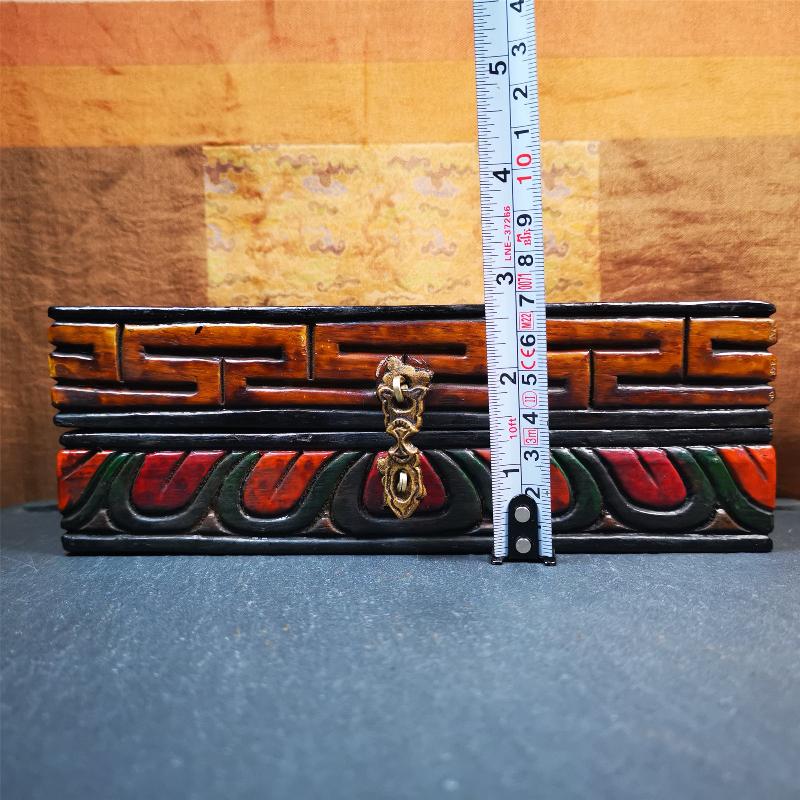 This vajra set was handmade in Nepal,using traditional techniques and materials. The Nine-pronged vajra is made of brass, and the outer box is made of wood,carved with the Tibetan letter of three karmas of word, thought , and deed The vajra can be inserted into the top of the box