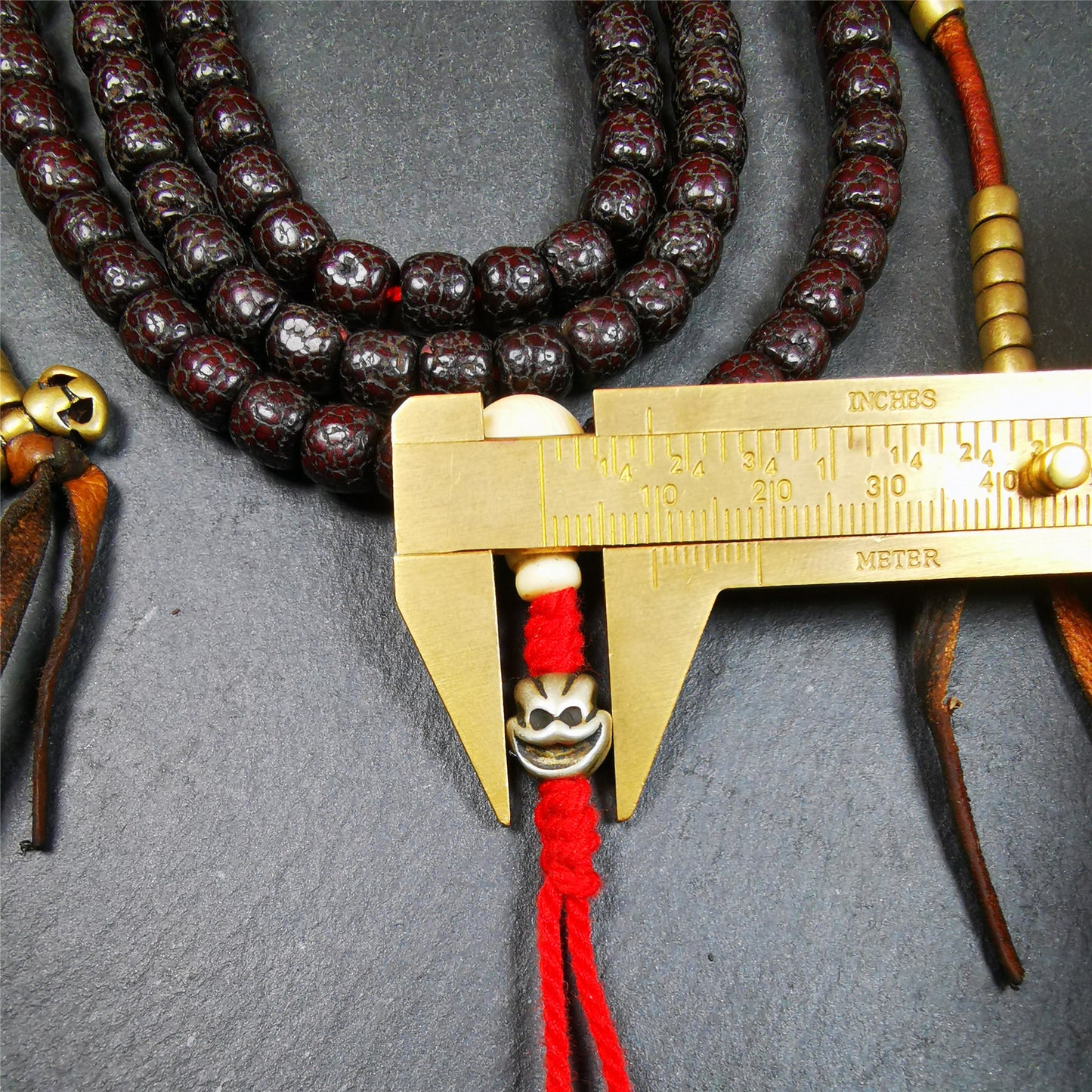 This mala is made by Tibetan craftsmen and come from Hepo Town, Baiyu County,Tibet, the birthplace of the famous Tibetan handicrafts,about 30 years old,blessed by a lama in Baiyu Monastery. It's made of lotus seed beads,brown color,with 1 pair of copper bead counters, and a cold iron skull bead on the tail.