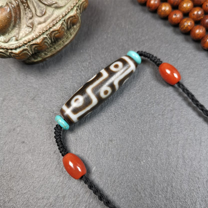 This 9 eyes dzi necklace was hand-woven by Tibetans from Baiyu County, the main bead is a 9 eyed  dzi bead, paired with 2 small agate beads and 2 turquoise spacer beads,about 30 years old.