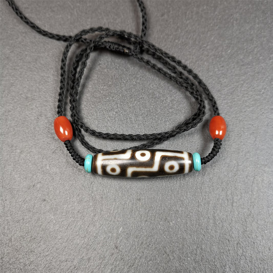 This 9 eyes dzi necklace was hand-woven by Tibetans from Baiyu County, the main bead is a 9 eyed  dzi bead, paired with 2 small agate beads and 2 turquoise spacer beads,about 30 years old.