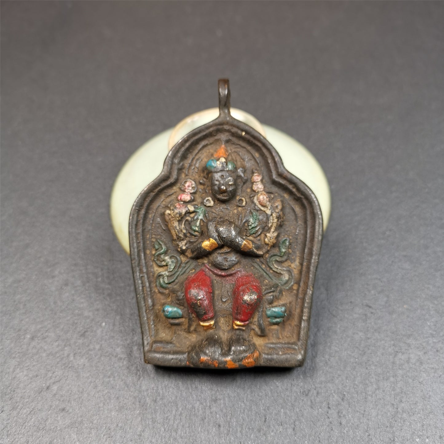 This maitreya statue was collected from Labrang Monastery,Qinghai,about 80 years old. It is an amulet of maitreya,made of copper,painted with mineral pigments,size is 2.95 by 1.97 inches,about 80 years old.