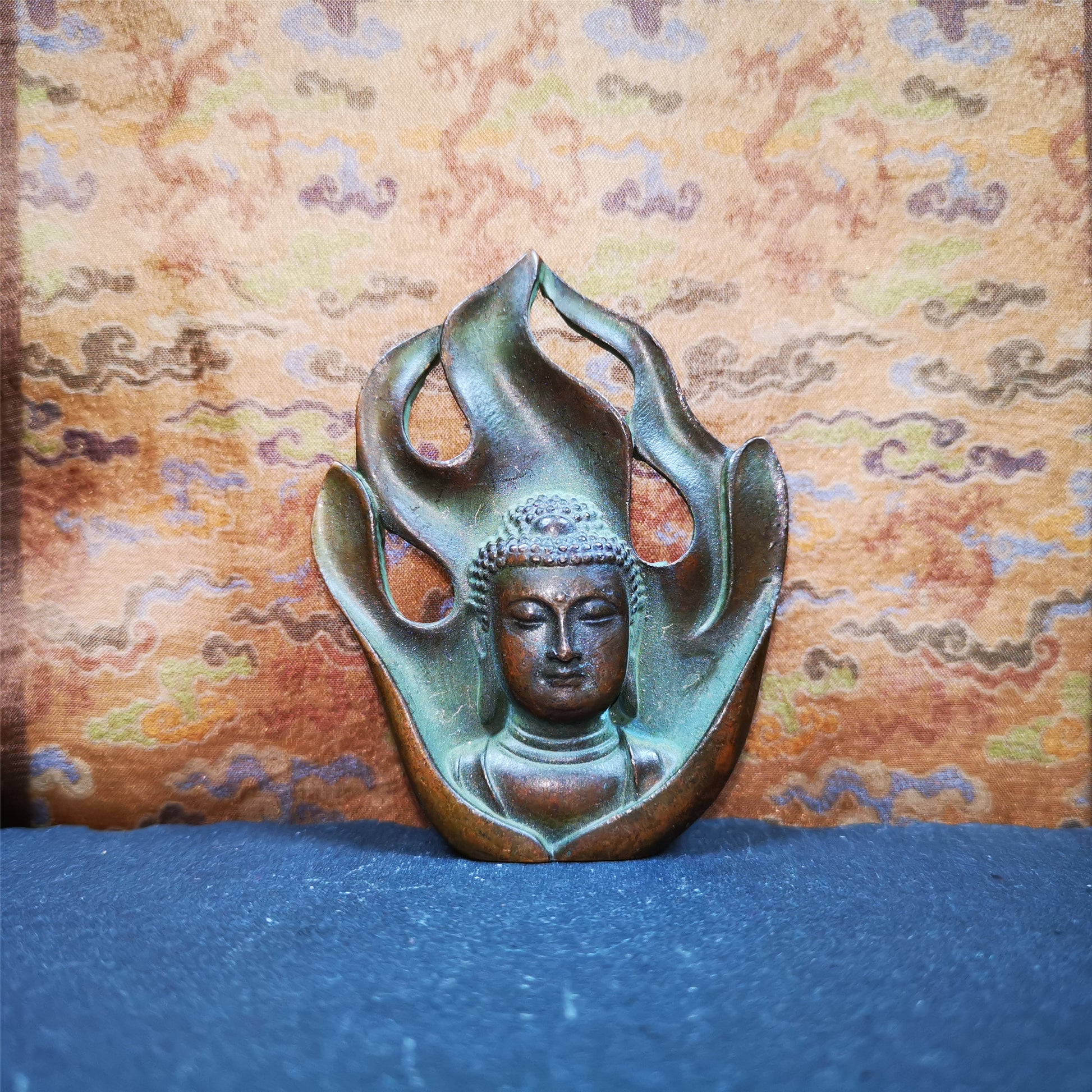 This shakyamuni statue was handmade from Baiyu Tibet. It is made of copper,the flame surrounds shakyamuni,the height is 2.9 inches,width is 1.85 inches.