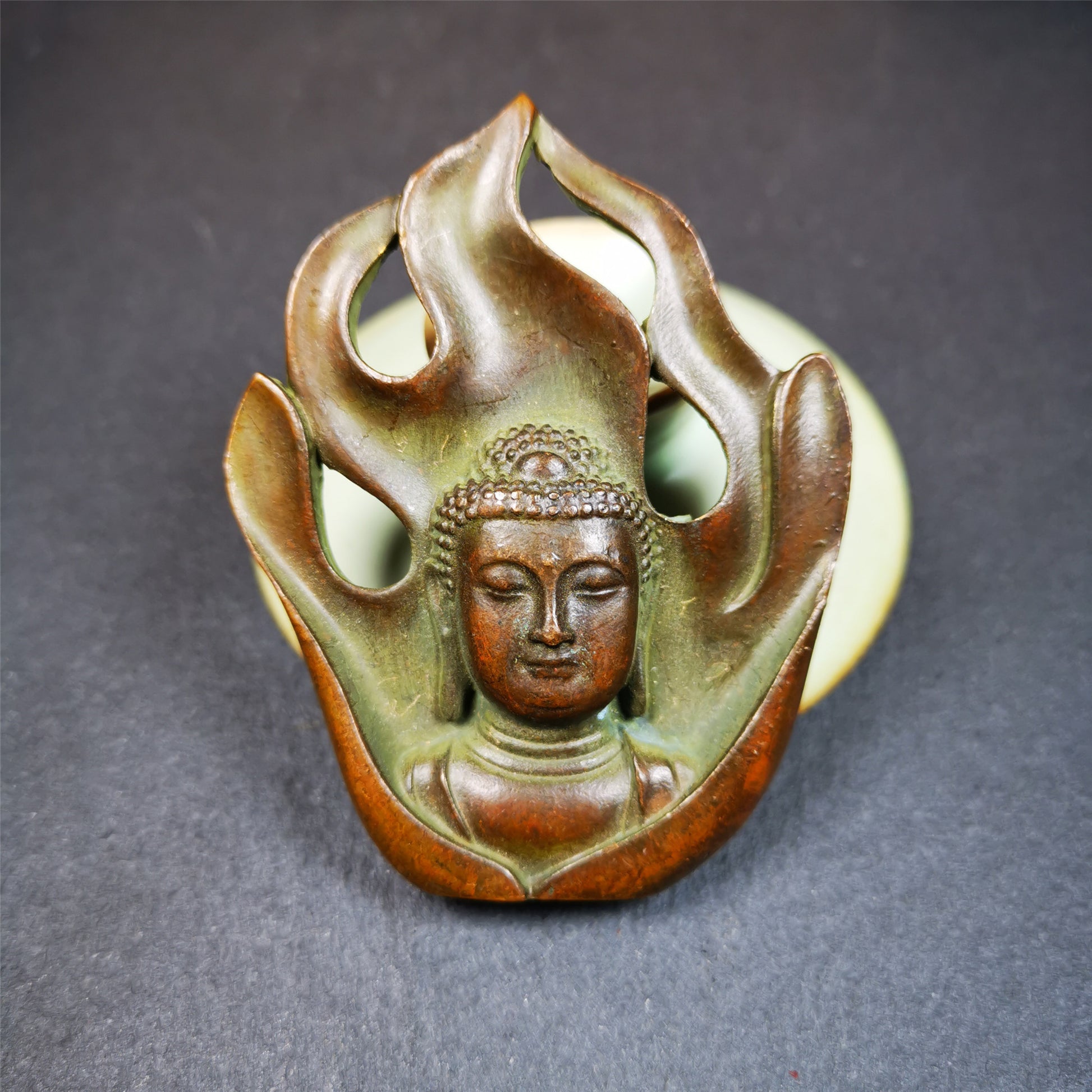 This shakyamuni statue was handmade from Baiyu Tibet. It is made of copper,the flame surrounds shakyamuni,the height is 2.9 inches,width is 1.85 inches.