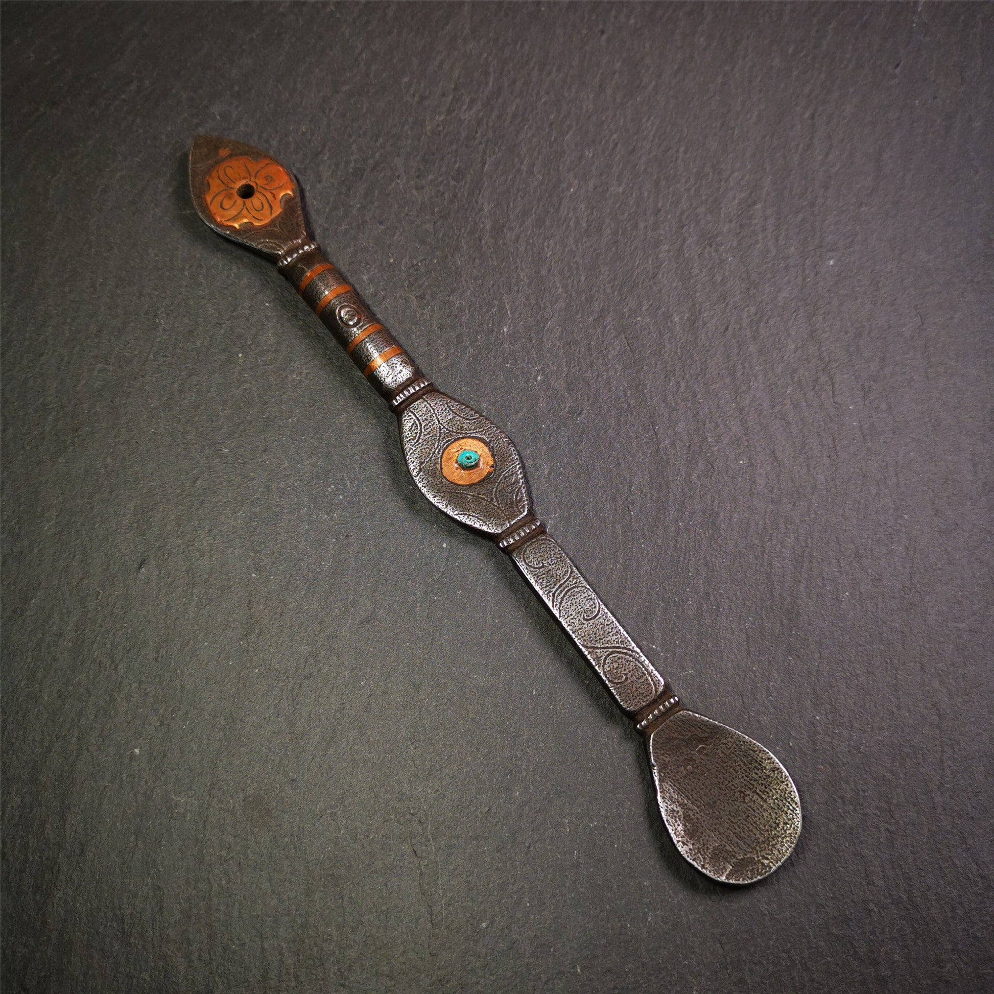 This spoon is handmade by Tibetan craftsmen from Tibet. It is entirely hand-carved with cold iron and copper,lenght about 7.5 inches. You can see teh intricate engraved detail along the handle, neck and bowl,very beautiful.