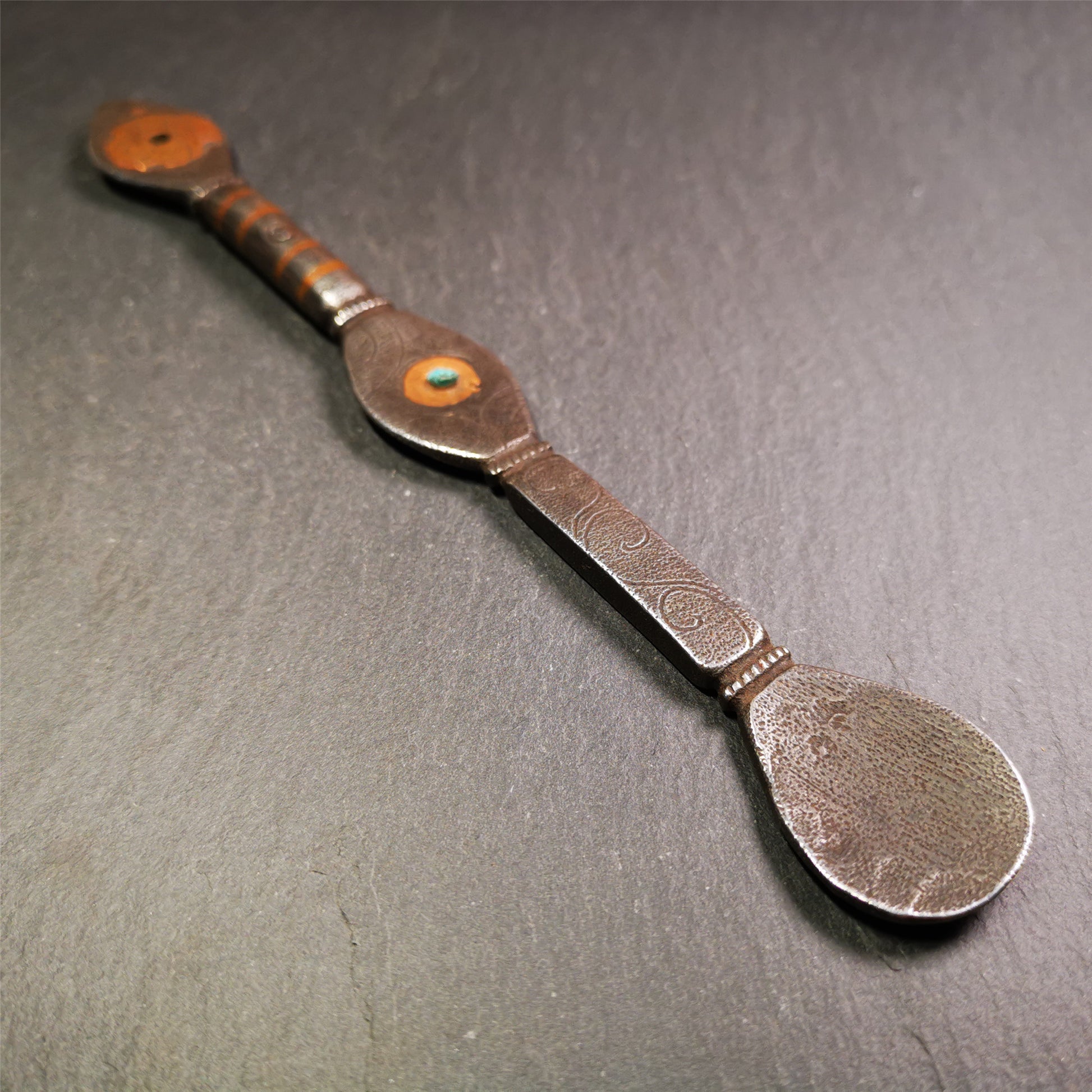 This spoon is handmade by Tibetan craftsmen from Tibet. It is entirely hand-carved with cold iron and copper,lenght about 7.5 inches. You can see teh intricate engraved detail along the handle, neck and bowl,very beautiful.