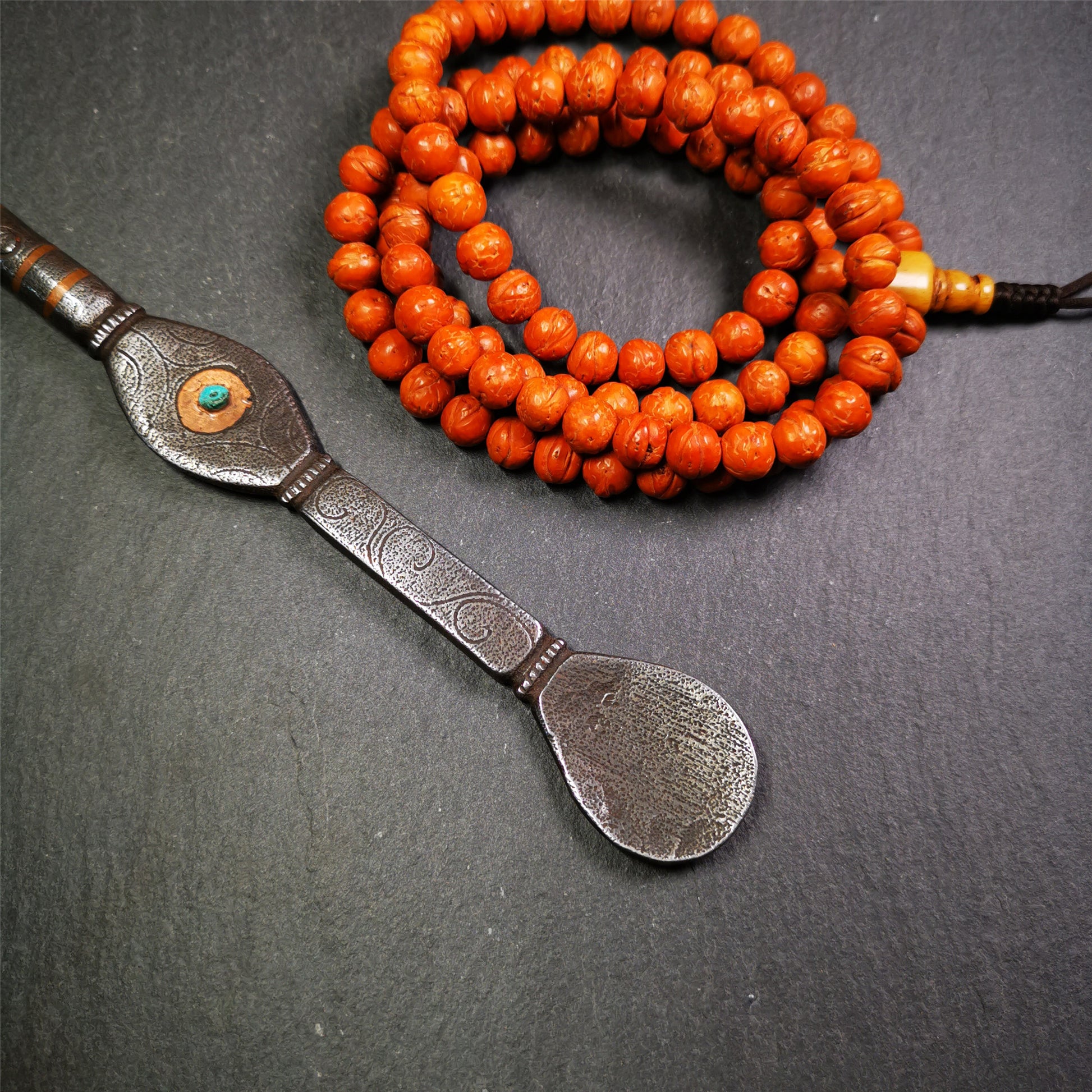 This spoon is handmade by Tibetan craftsmen from Tibet. It is entirely hand-carved with cold iron and copper,lenght about 7.5 inches. You can see teh intricate engraved detail along the handle, neck and bowl,very beautiful.