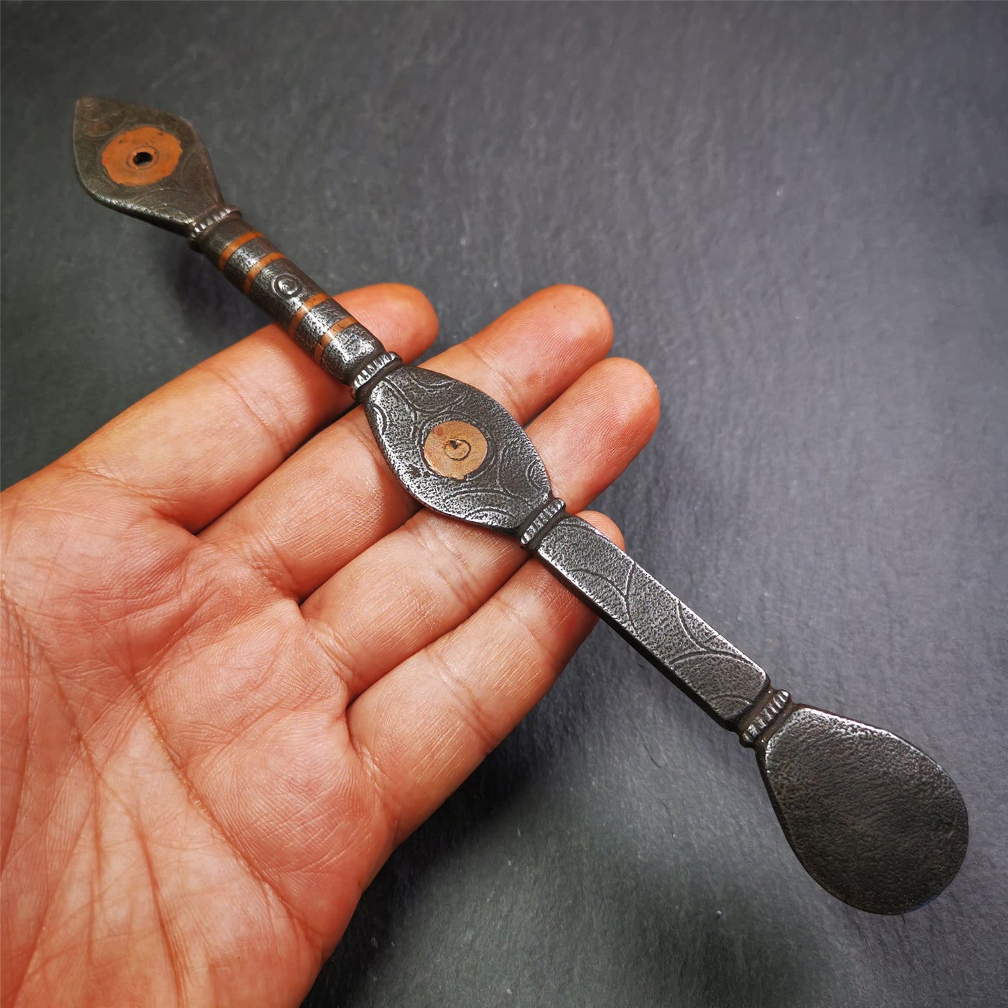 This spoon is handmade by Tibetan craftsmen from Tibet. It is entirely hand-carved with cold iron and copper,lenght about 7.5 inches. You can see teh intricate engraved detail along the handle, neck and bowl,very beautiful.