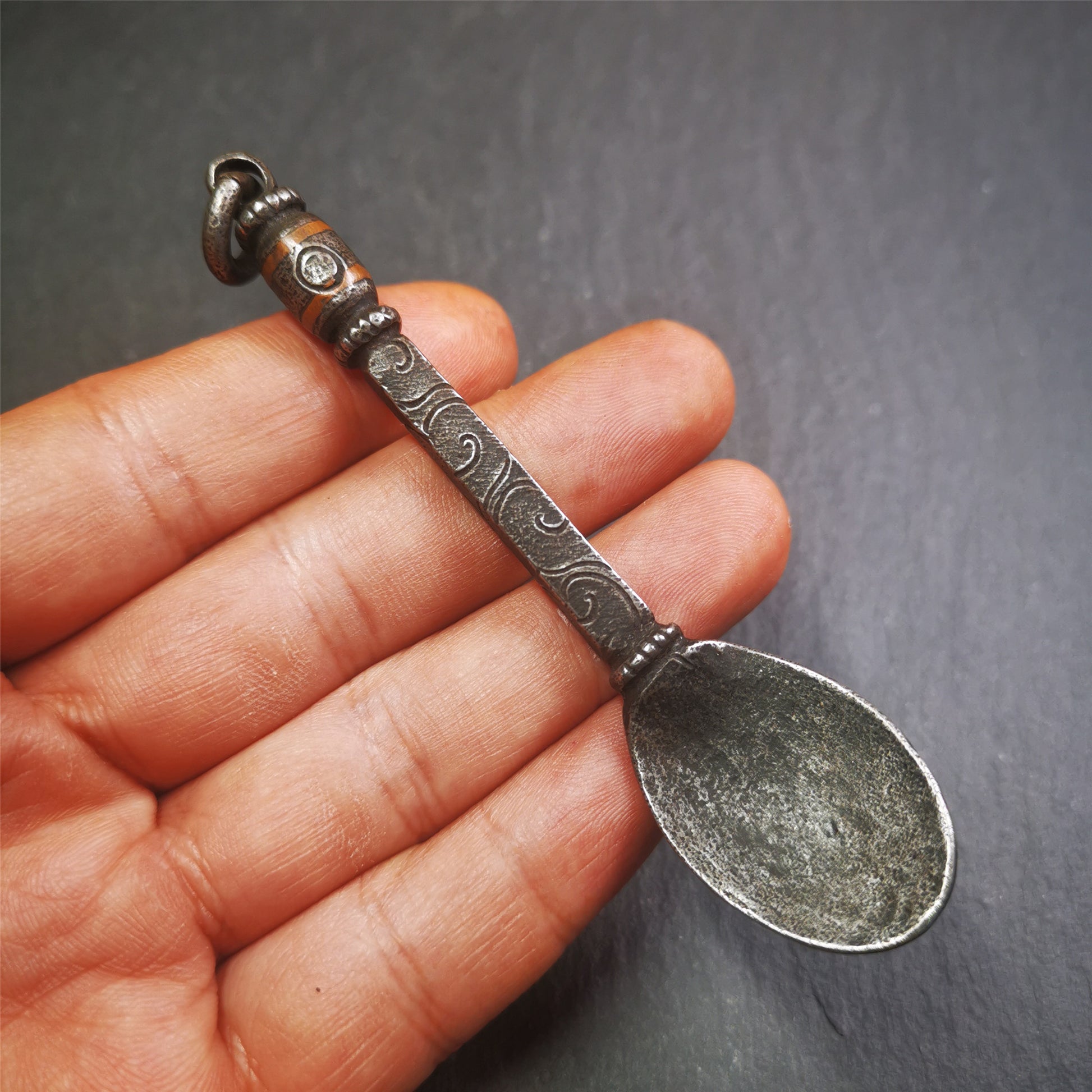 This offering spoon is handmade by Tibetan craftsmen from Hepo Town, Baiyu County,the birthplace of the famous Tibetan handicrafts. It is entirely hand-carved with cold iron and copper,lenght about 4.0 inches.