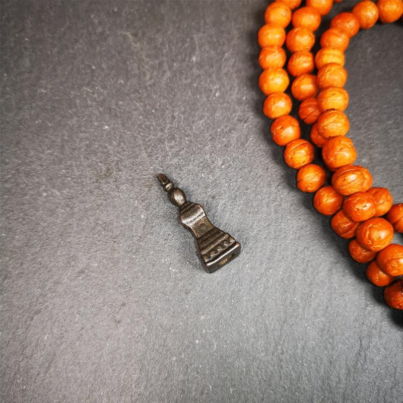 This stupa amulet pendant wss hand carved by Tibetan craftsmen from Tibet in 1990's. From Hepo Town, Baiyu County, the birthplace of the famous Tibetan handicrafts. It was made of cold iron,black color,1.22 inches heiht. You can make it necklace pendant,mala pendant,keychain, or just put it on your desk,as an ornament.