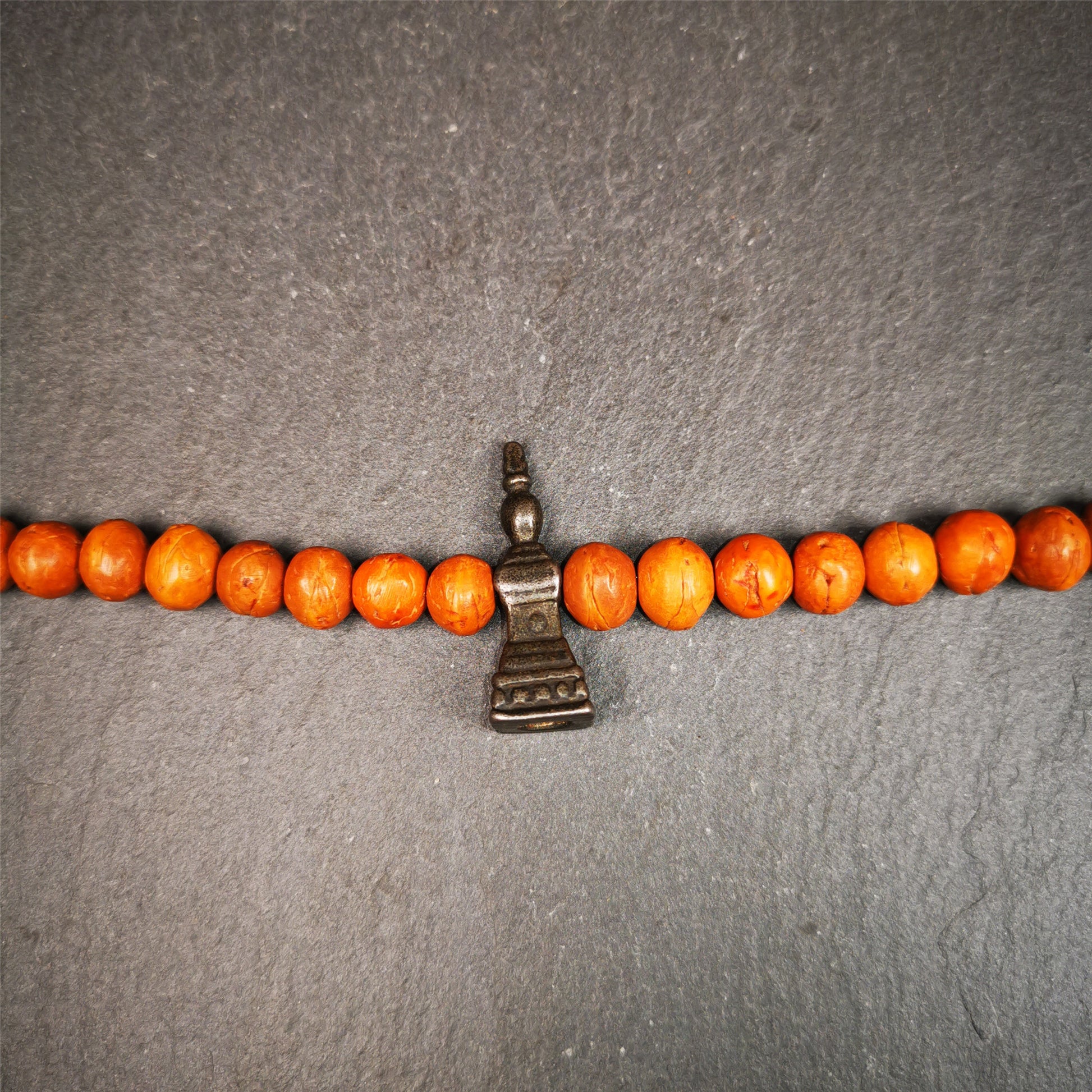 This stupa amulet pendant wss hand carved by Tibetan craftsmen from Tibet in 1990's. From Hepo Town, Baiyu County, the birthplace of the famous Tibetan handicrafts. It was made of cold iron,black color,1.22 inches heiht. You can make it necklace pendant,mala pendant,keychain, or just put it on your desk,as an ornament.