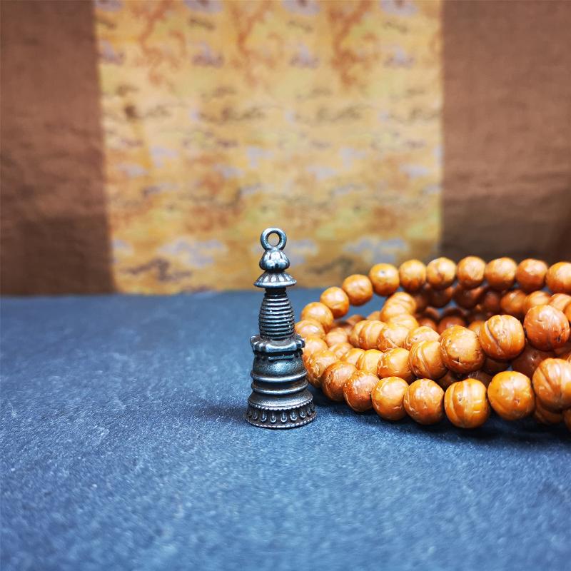 This beautiful stupa pendant is hand carved by Tibetan craftsmen from Tibet in 2000's. From Hepo Town, Baiyu County, the birthplace of the famous Tibetan handicrafts. It was made of cold iron,black color,1.38 inches height, a cross vajra seal at the bottom.  You can make it into a pendant, or a keychain, or put it in your shrine.