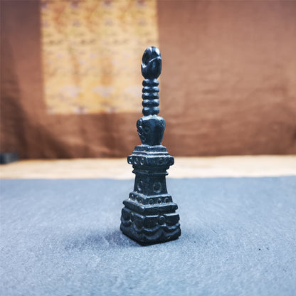 This beautiful stupa pendant is hand carved by Tibetan craftsmen from Tibet in 2000's. From Hepo Town, Baiyu County, the birthplace of the famous Tibetan handicrafts. It was made of obsidian, all black color,2.95 inches height. At the bottom of it is engraved with the Tibetan word OM.